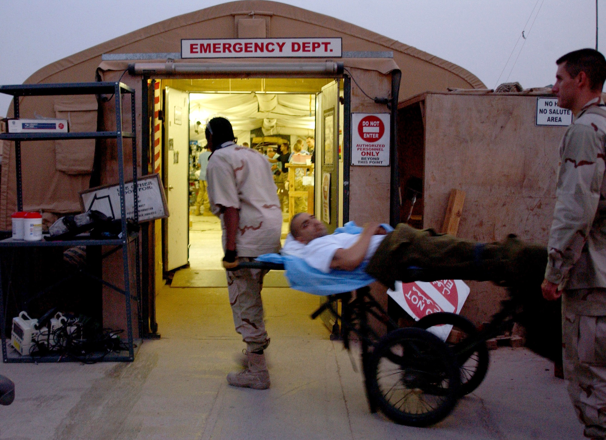 Medics from 332nd Expeditionary Medical Group emergency room and Contingency Aeromedical Staging Facility bring Army Cpl. Erick Rodriguez into the Air Force Theater Hospital's Emergency Room Aug. 3. Corporal Rodriguez sustained abdominal injuries from an improvised explosive device. He was the last patient to be treated in the Air Force Theater Hospital's tent facility. Corporal Rodriguez, assigned to Forward Operating Base Warhorse, is a cavalry scout with the 2nd Infantry Division, deployed from Ft. Lewis, Wash. (U.S. Air Force photo/1st Lt. Shannon Collins)