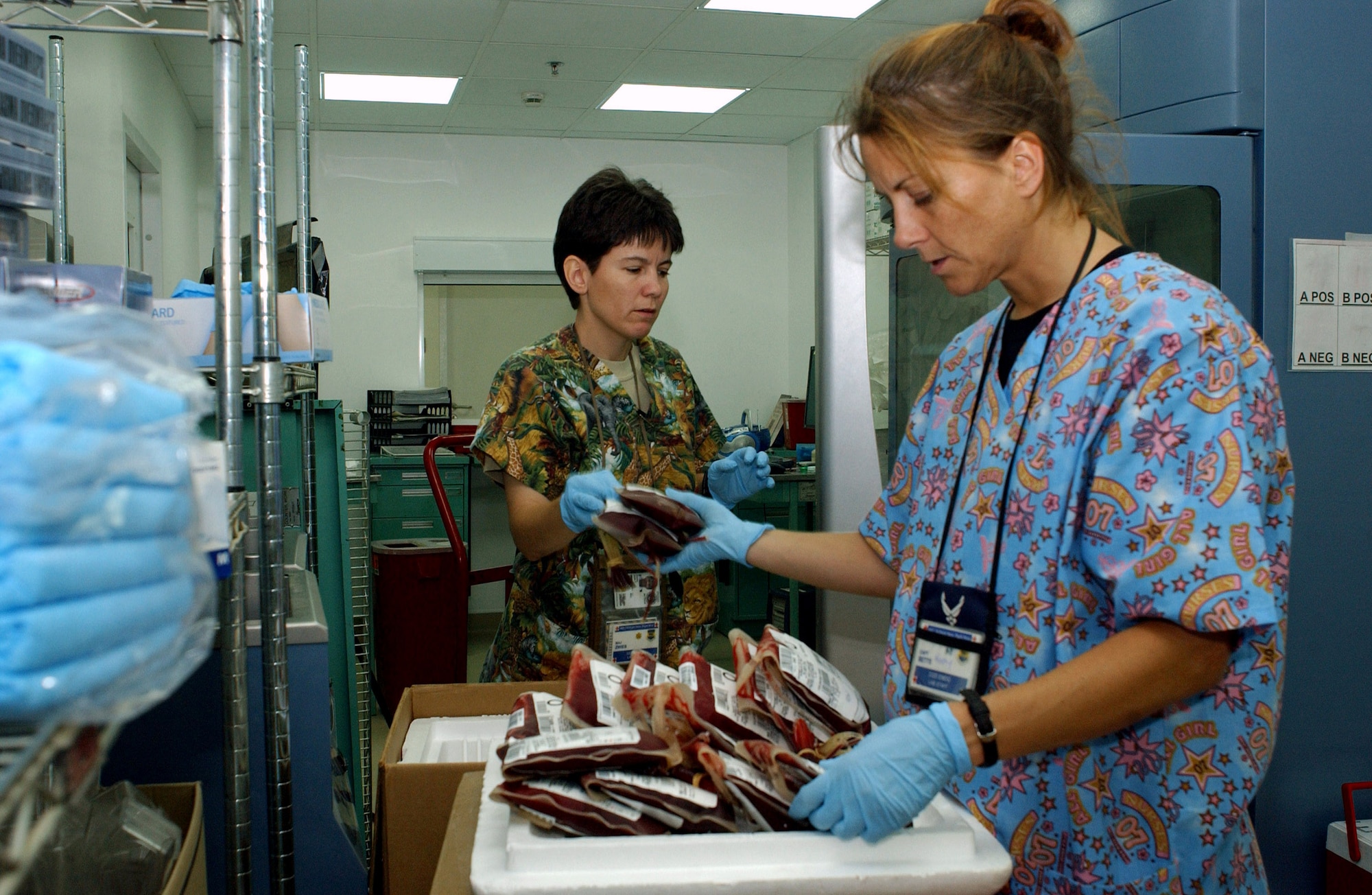 Maj. Julie Zwies and Capt. Kathy Betts inventory equipment at the new Air Force Theater Hospital at Balad Air Base, Iraq, Aug. 3. Starting at 4 a.m., about 150 base volunteers and 380 332nd EMDG Airmen moved patients and equipment to the newly upgraded, pre-engineered facility. Major Zwies and Captain Betts are assigned to the 332nd Medical Group lab flight. (U.S. Air Force photo/1st Lt. Shannon Collins)