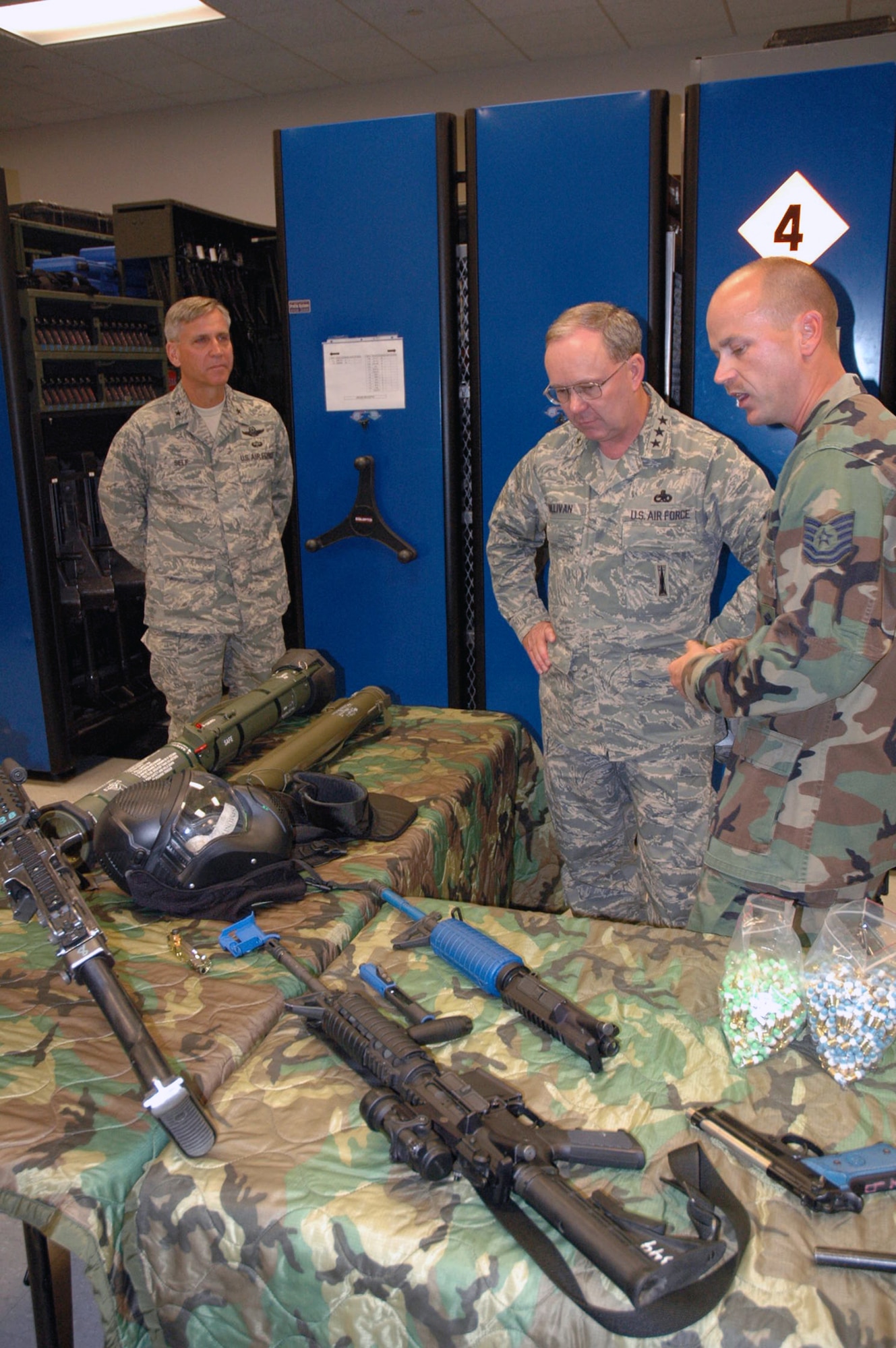 Brig. Gen. Kip Self, U.S. Air Force Expeditionary Center commander, and Lt. Gen. Kevin J. Sullivan, Deputy Chief of Staff for Logistics, Installations and Mission Support, Headquarters U.S. Air Force, Washington, D.C., listen to Tech. Sgt. Charles Glunt, NCO in charge of the Center's armory, on what weapons are available for students to use at the Center Aug. 3, 2007, at Fort Dix, N.J.  The USAF EC's Armory is the Air Force's largest armory containing foreign weapons.  (U.S. Air Force Photo/Tech. Sgt. Scott T. Sturkol)
