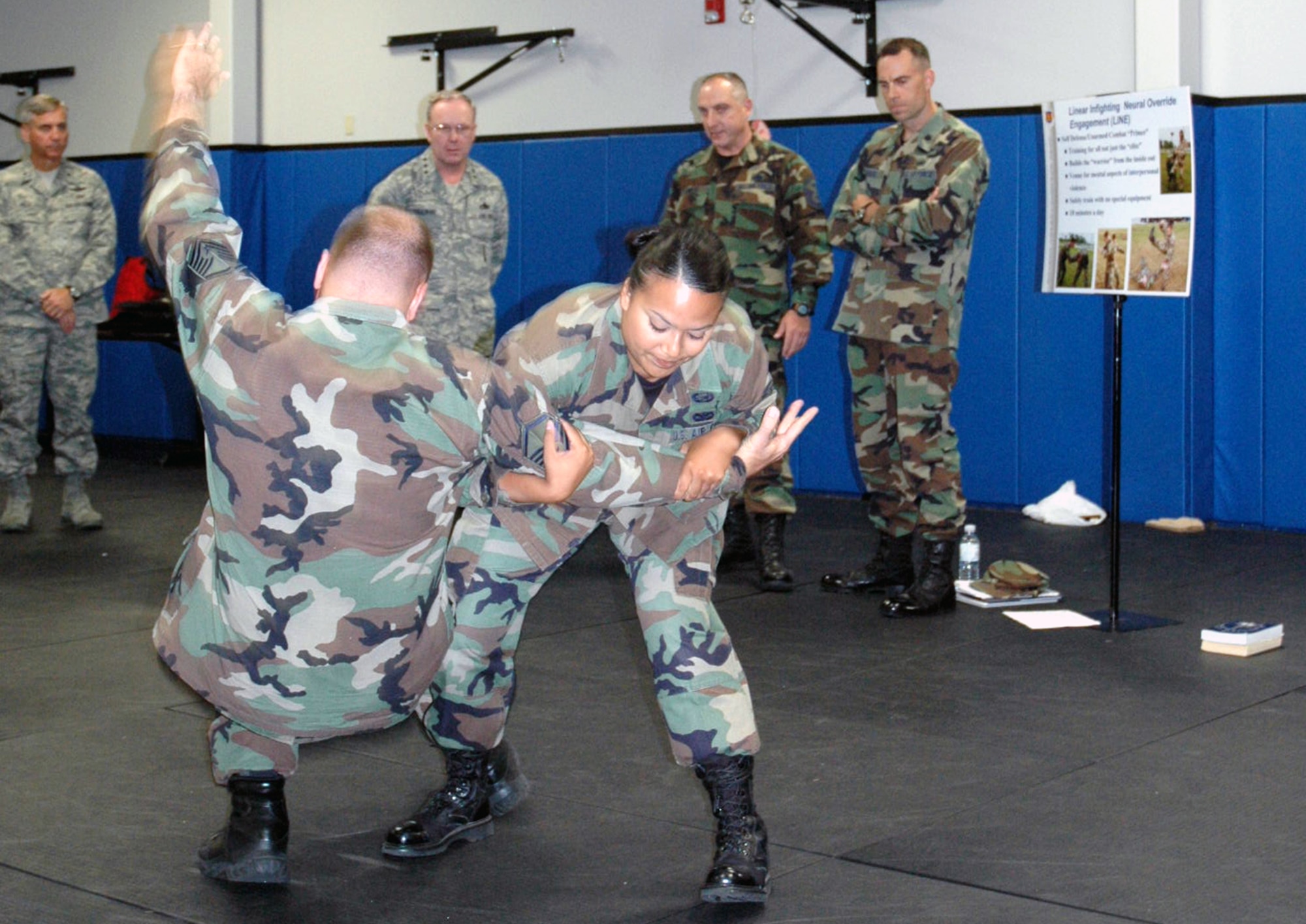 Master Sgt. Wayne Hall and Senior Airman Maria Mendez, both from the U.S. Air Force Expeditionary Center, participate in a self defense demonstration at the Center Aug. 3, 2007 at Fort Dix, N.J.  The Center teaches self defense in its Advanced Contingency Skills Training Course.  (U.S. Air Force Photo/Tech. Sgt. Scott T. Sturkol)