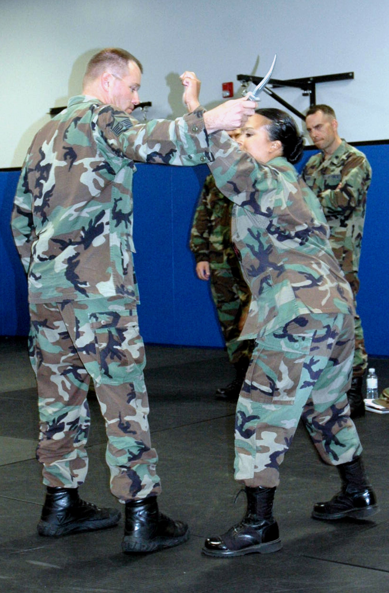 Master Sgt. Wayne Hall and Senior Airman Maria Mendez, both from the U.S. Air Force Expeditionary Center, participate in a self defense demonstration at the Center Aug. 3, 2007.  The Center teaches self defense in its Advanced Contingency Skills Training Course.  (U.S. Air Force Photo/Tech. Sgt. Scott T. Sturkol)