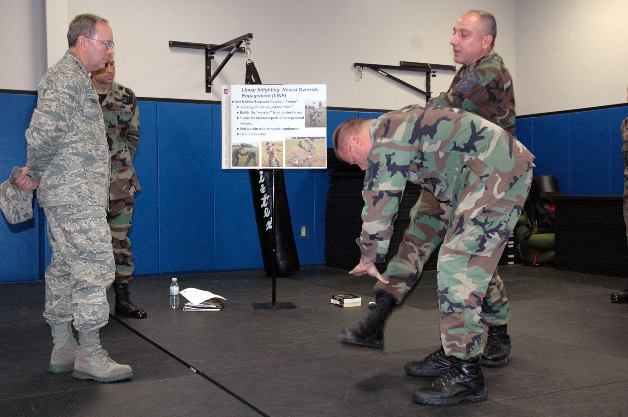 Master Sgts. Wayne Hall and Jack Smith, both from the U.S. Air Force Expeditionary Center, demonstrate self defense techniques to Lt. Gen. Kevin J. Sullivan, Deputy Chief of Staff for Logistics, Installations and Mission Support, Headquarters U.S. Air Force, Washington, D.C., during a visit to the U.S. Air Force Expeditionary Center Aug. 3, 2007, at Fort Dix, N.J.  General Sullivan is responsible to the Chief of Staff for leadership, management and integration of Air Force logistics readiness, aircraft and missile maintenance, civil engineering and security forces, as well as setting policy and preparing budget estimates that reflect enhancements to productivity, combat readiness and quality of life for Air Force people.  (U.S. Air Force Photo/Tech. Sgt. Scott T. Sturkol)