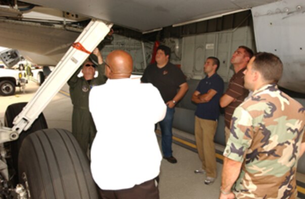 ANDREWS AFB, Md. -- Chief Master Sgt. Tony Parris, 756th Air Refueling Squadron chief boom operator, explains various parts of the underbelly of the KC-135 Stratotanker to a small group of Defense Intellingence Agency employees.  Chief Parris led about a dozen of the DIA employees on a tour of the 459th Air Refueling Wing's KC-135 on Aug. 10.