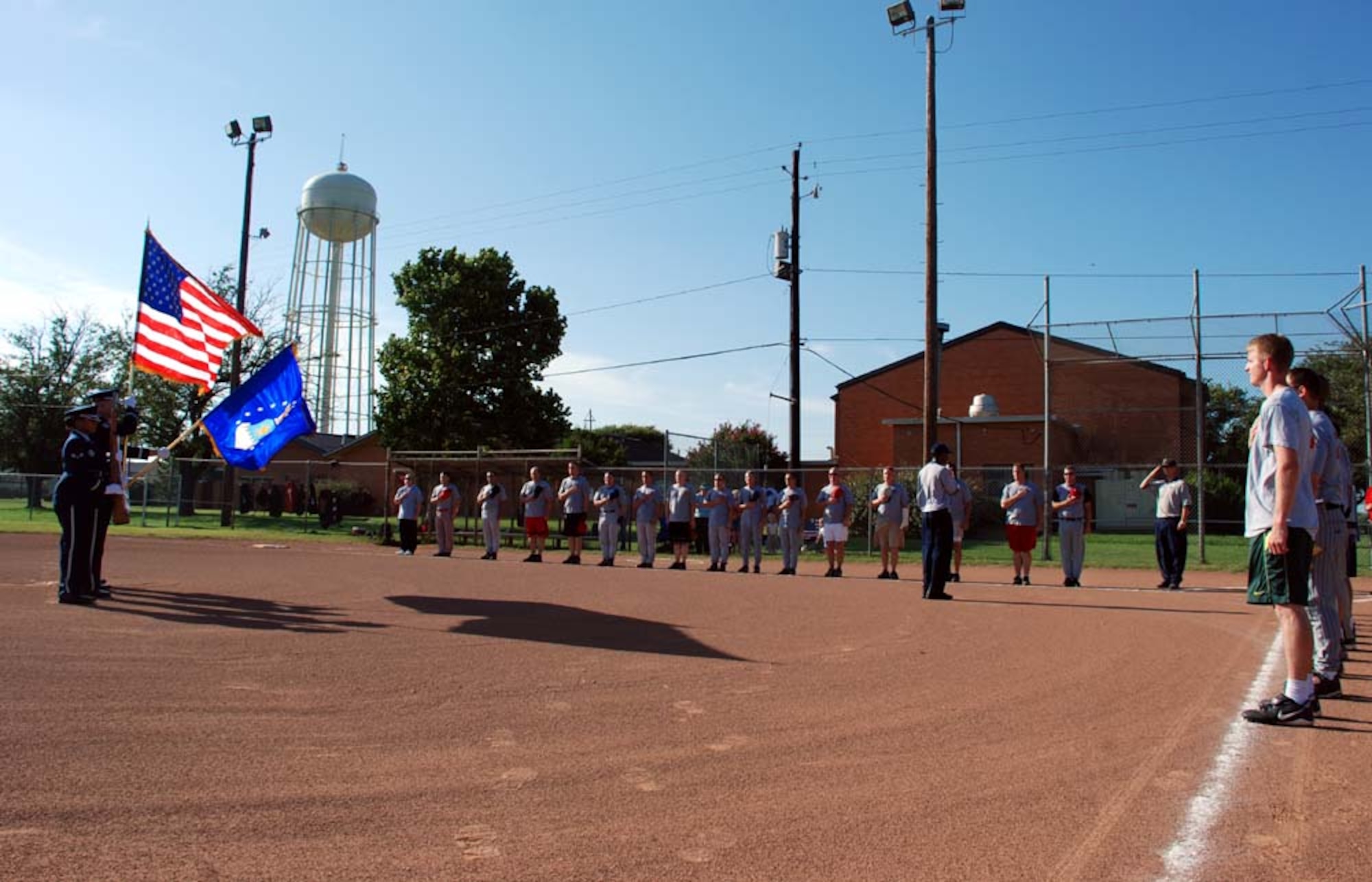 The 89th/90th Flying Training Squadron Banshees and the 382nd Training Squadron/882nd Training Support Squadron stand during the national anthem at the 2007 Intramural Softball Championships Aug. 7. The Banshees defeated the 382nd TRS/882nd TRSS. (U.S. Air Force photo/Airman 1st Class Jacob Corbin)