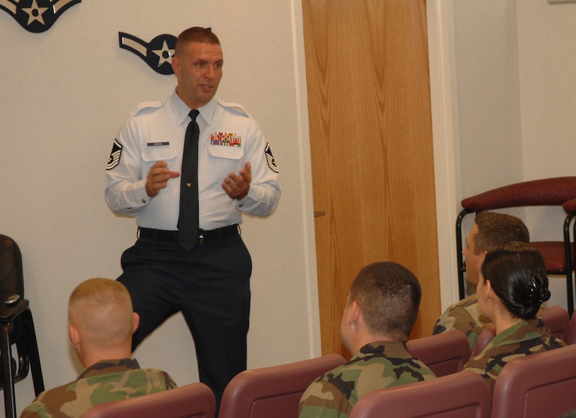 MINOT AIR FORCE BASE, N.D. -- Master Sgt. Craig Poessl, Air Education and Training Command Recruiter Screening Team member, briefs Airmen at the Airman Leadership School here Aug. 9 about becoming Air Force recruiters or military training instructors. Sergeant Poessl explained to Airmen how recruiters and MTIs must adhere to the highest Air Force standards because they are the first people future Airmen and basic trainees come in contact with. (U.S. Air Force photo by Airman 1st Class Cassandra Jones)