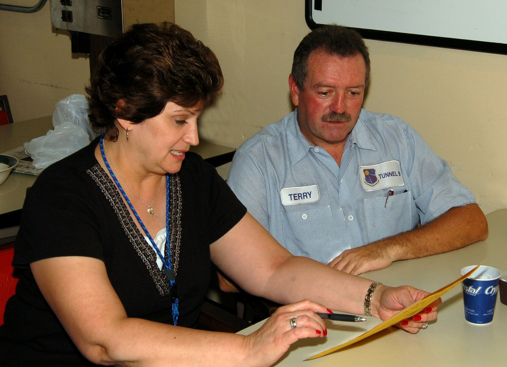 Tunnel 9's Carol Paschall discusses a purchase with Tunnel 9 operations team member Terry Mullin. 