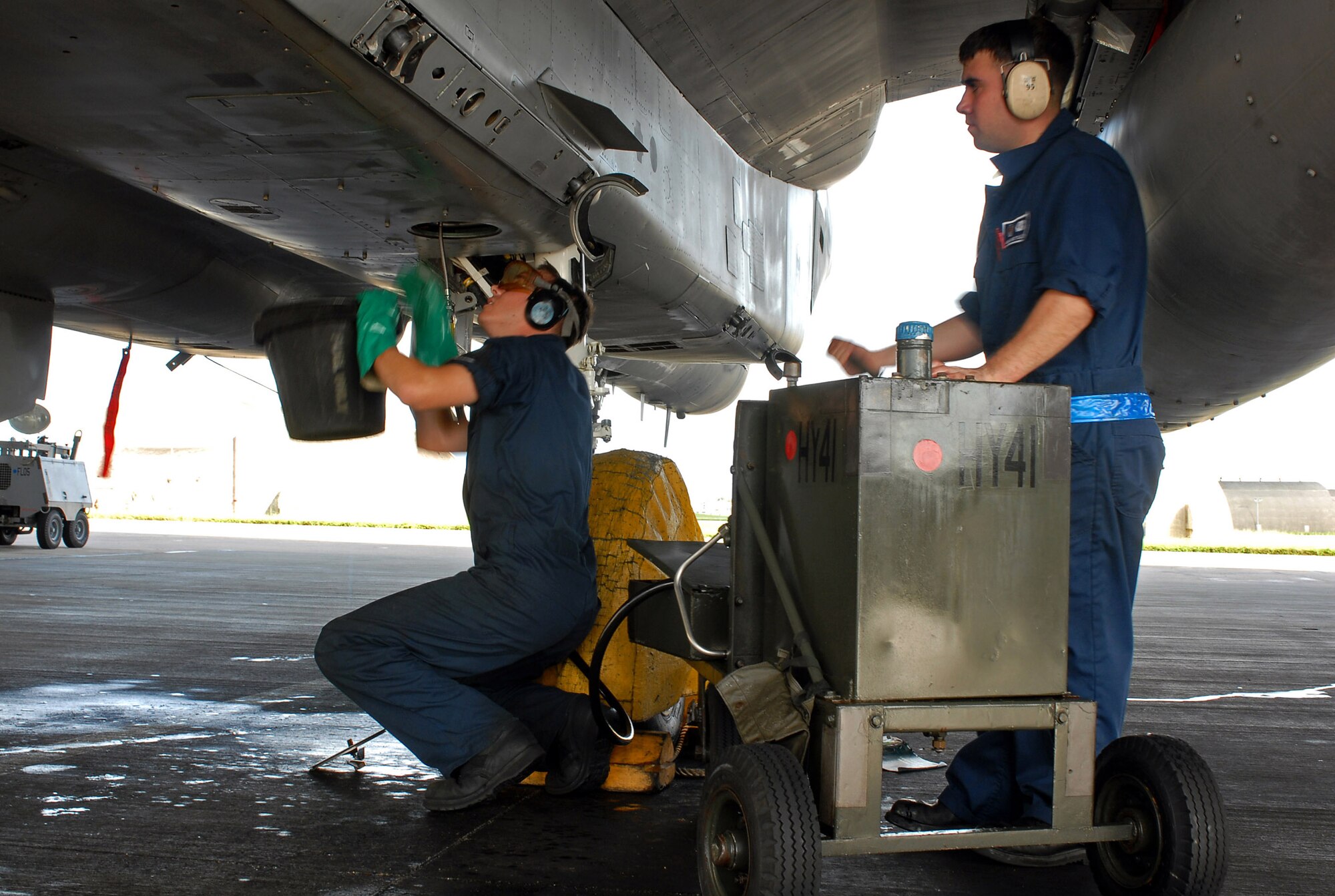 Airman 1st Class John Miller (left) and Airman David Tillich check the utilities systems of an F-15 in preparation for aircraft departure to Guam in support of Exercise Valiant Shield Eagle Aug. 5 at Kadena Air Base, Japan. Air Force leaders are considering realigning aircraft maintenance units directly into flying squadrons. (U.S. Air Force photo/Airman 1st Class Kelly Timney)