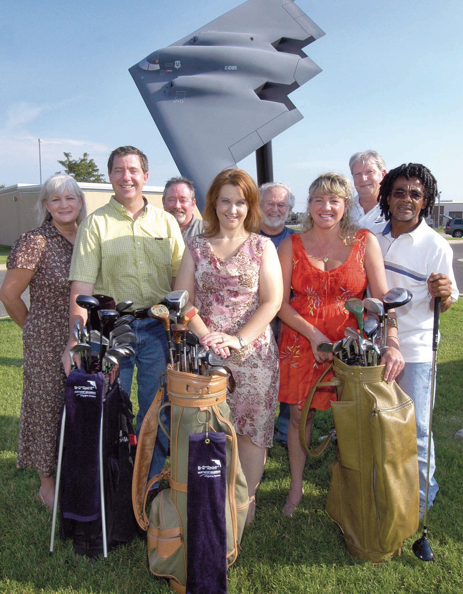 B-2 personnel rallied after learning a coworker’s deployed husband and other Airmen shared one broken golf club during down time.  Angela Carr, center, is surrounded by coworkers and a few of the golf supplies going overseas.  From left are; Diane Elliott, Kirk Johnson, Tommy Mills, Charlie Hogan, Tina Croswell, Randy Lynn and Gary Kinard.  (Air Force photo by Margo Wright)
