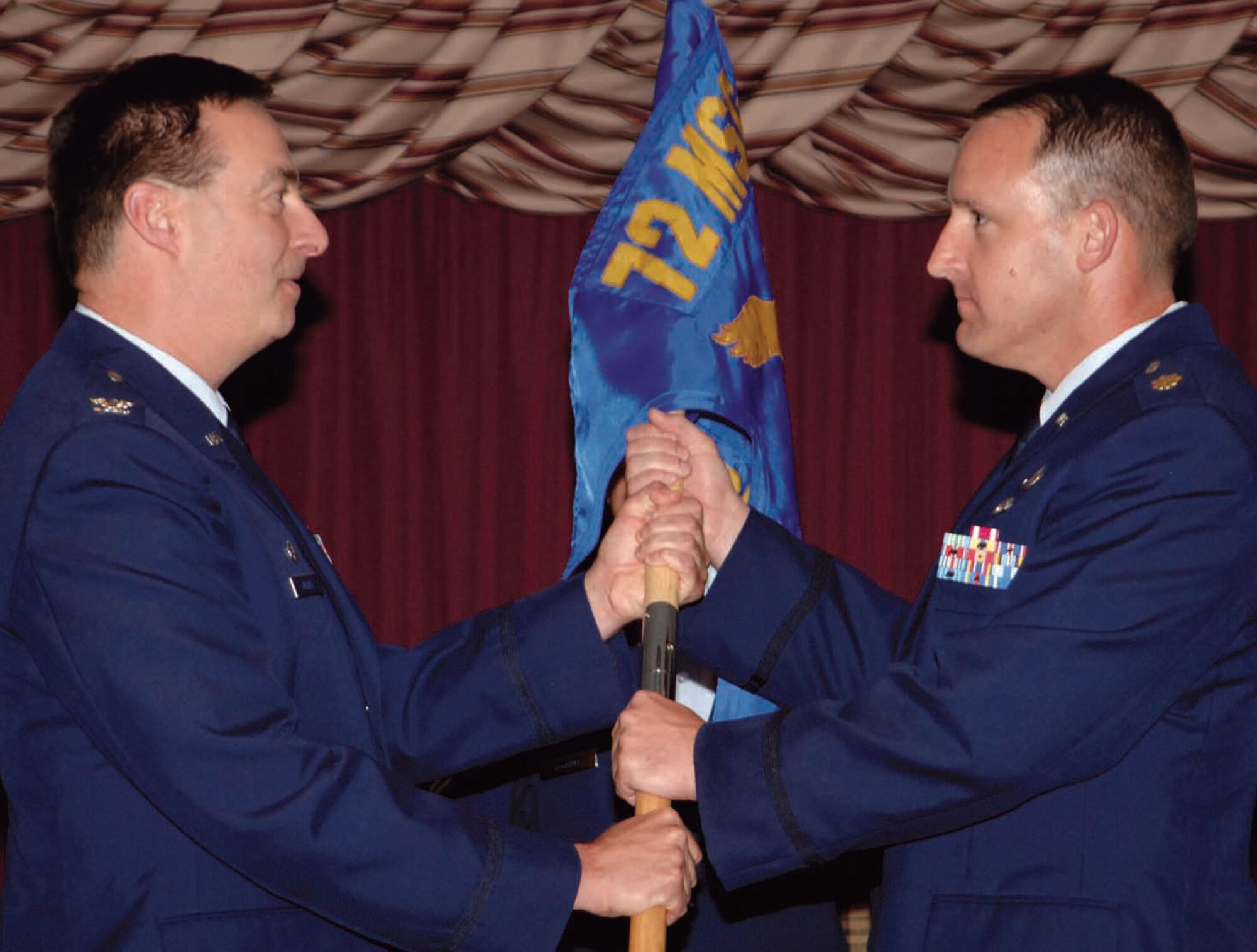 Maj. Richard Ward, right, accepts command of the 72nd Contracting Squadron conferred by Col. James Eilers, 72nd Mission Support Group commander, during an Aug. 3 ceremony. (Air Force photo by Kelly Sharp)