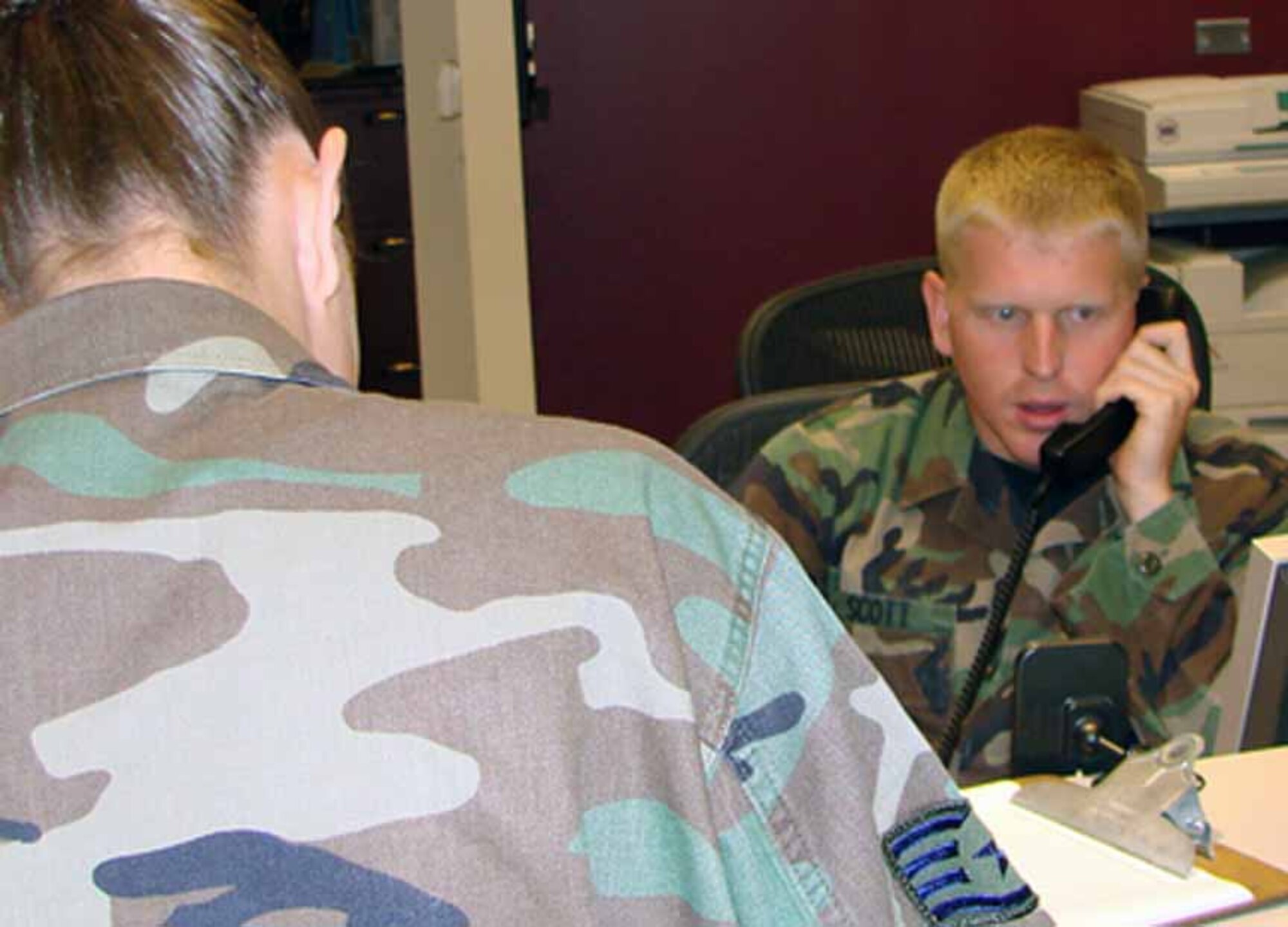 Staff Sgt. Chris Scott checks in a customer at the front desk of the Family Support Center. Personnel needing assistance must now make an appointment before visiting the FSC. The appointment system is reducing the time customers have to wait before seeing an FSC staff member. (Air Force photo by Alfredia P. McGill)