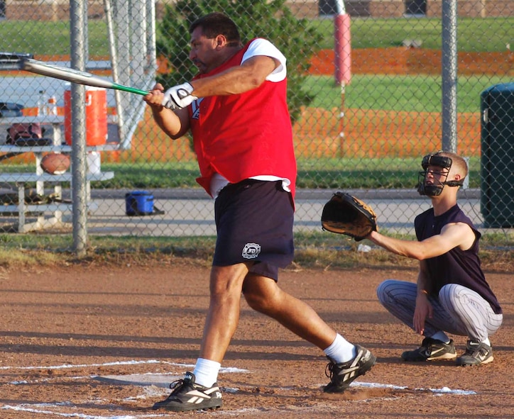 Tinker Fire Department catcher Tom Trella drives the ball out of the infield during a game against the 34th Combat Communications Squadron. (Air Force photo by John E. Banks)