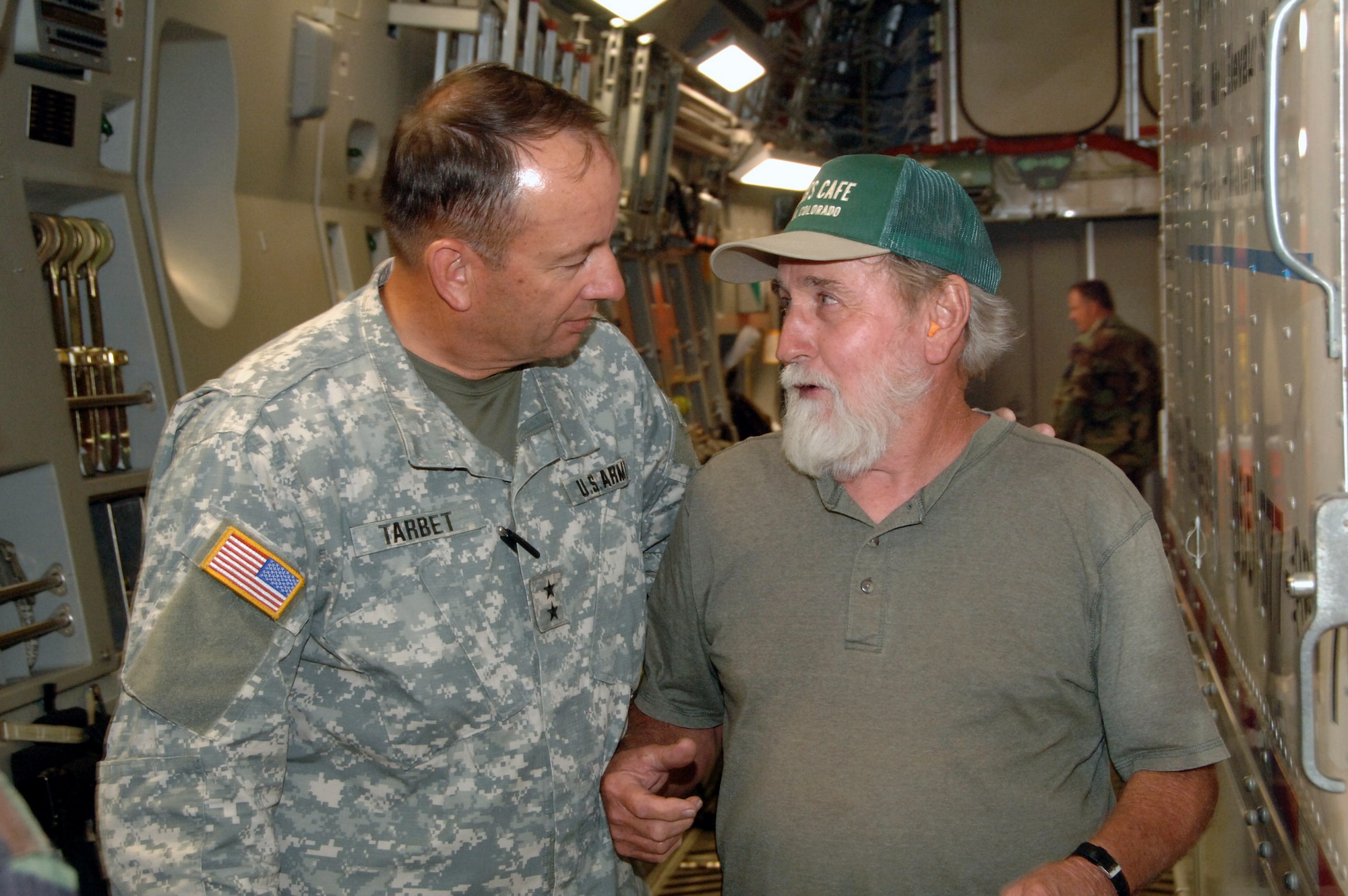 Army Maj. Gen. Brian Tarbet welcomes George Rollins to Salt Lake Aug. 9 after Mr. Rollins drove across the country to deliver a critical piece of equipment to rescuers of six Utah miners. The equipment will allow rescuers the ability to position a camera in the mine and assess the situation from a 360-degree angle. It will allow rescue crews to have a better idea of conditions inside the collasped mine. General Tarbet is the adjutant general of Utah. (U.S. Air Force photo/Master Sgt. Burke Baker)
