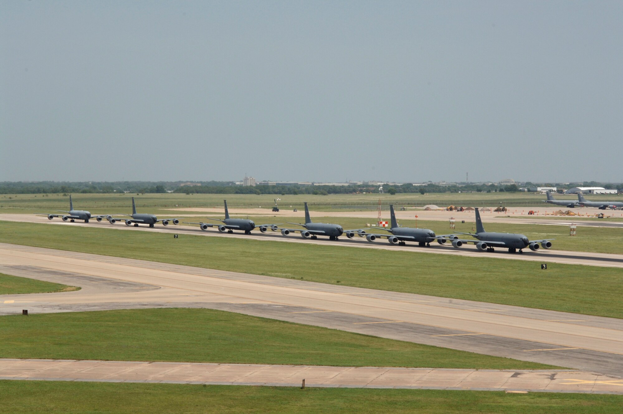 MCCONNELL AIR FORCE BASE, Kan. -- Six McConnell KC-135 Stratotankers demonstrate the "elephant walk" formation as they taxi down a runway here Aug. 5 during a generation exercise. The exercise showcased McConnell aircrews’ capability to prepare a flight and take off within minutes of being notified of a mission. These types of exercises are conducted randomly each year. (Photo by Tech. Sgt. Chyrece Campbell)