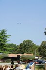 Those attending the dedication gaze skyward as two F-15Cs from the 46th Test Wing at Eglin AFB perform a flyover, a tradition dating back to World War I.