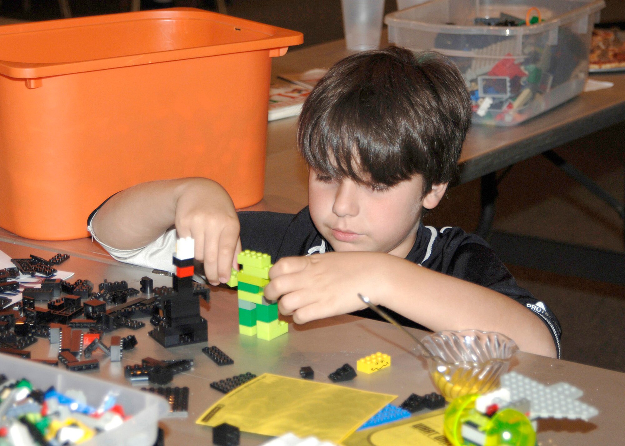 MCONNELL AIR FORCE BASE, Kan. -- Rhys Pritchett, 10, Team McConnell family member, plays with building blocks during the Lego workshop at Robert J. Dole Community Center, Aug. 2. The workshop helps members share ideas for the upcoming Create a Masterpiece Contest.  (Photo by Amn Justin Shelton)