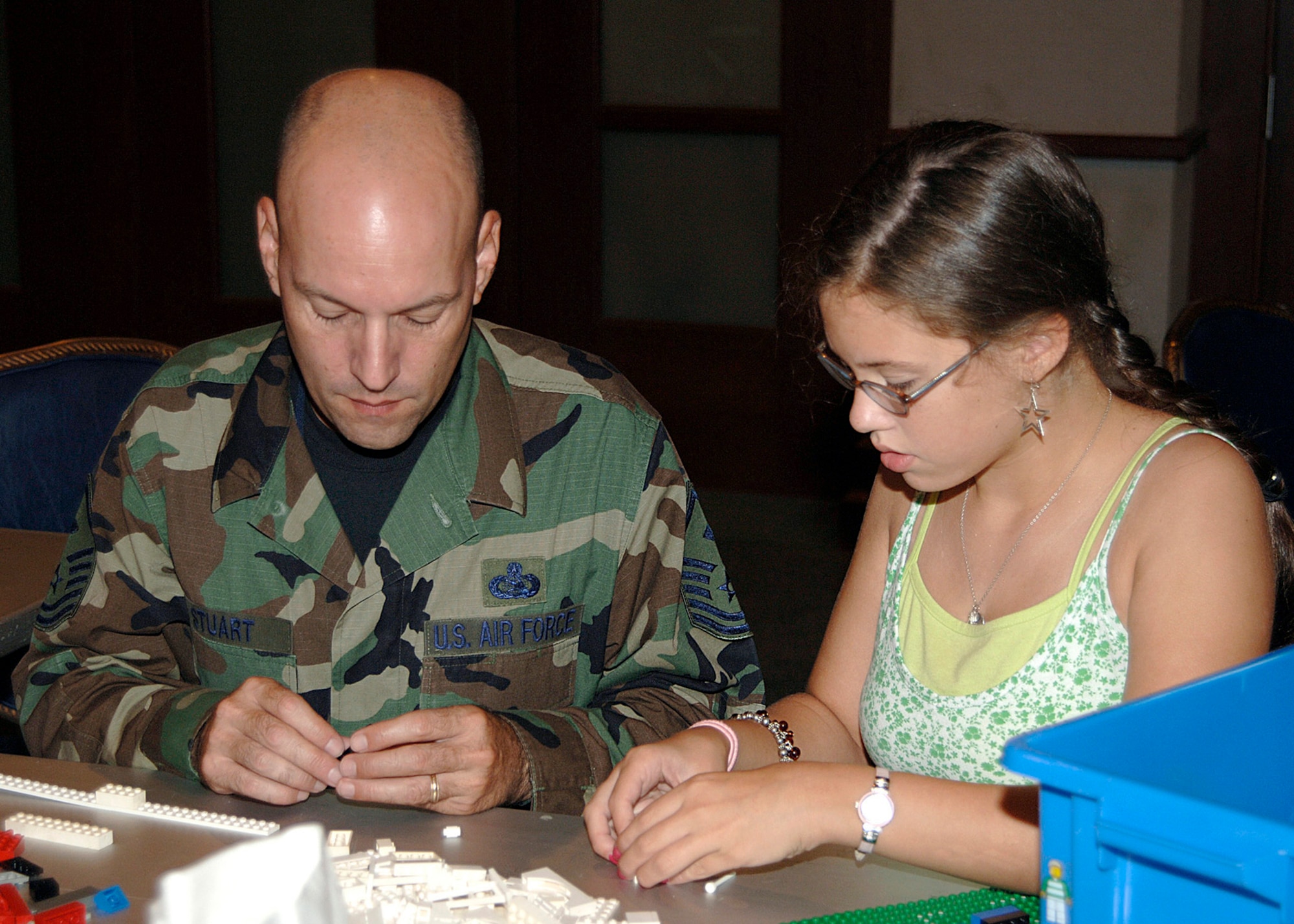 MCCONNELL AIR FORCE BASE, Kan. – Master Sgt. Larry Stuart, 22nd Maintenance Squadron, and his daughter Abigail, 11, play with building blocks during the Lego workshop at Robert J. Dole Community Center, Aug. 2.  The Lego workshop helps members share ideas for the upcoming Create a Masterpiece Contest.  (Photo by Amn Justin Shelton)