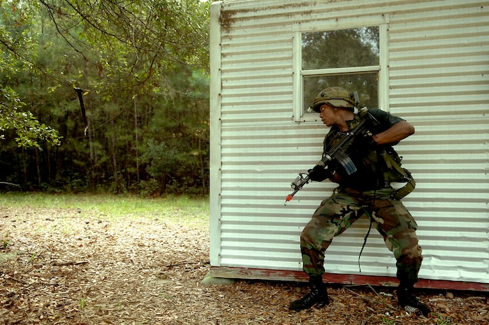 Airman 1st Class Anderson Nanton, 437th Aerial Port Squadron aerial port specialist, tactically looks around the corner for insurgents during training on Charleston AFB Tuesday.  (U.S. Air Force photo/Airman 1st Class Nicholas Pilch) 
