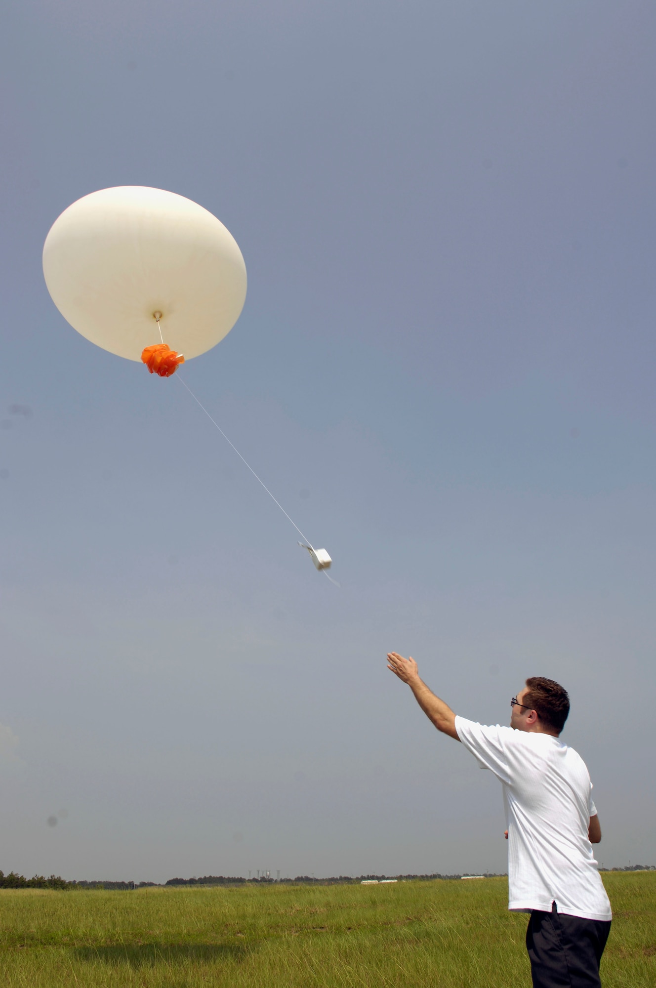 EGLIN AIR FORCE BASE, Fla. -- Mike Bouvender, a contractor with Control Systems Research, Inc., launches a weather balloon Aug. 8. The balloons are used to gather data that supports many of the missions here. (AF photo by Greg Murry)
