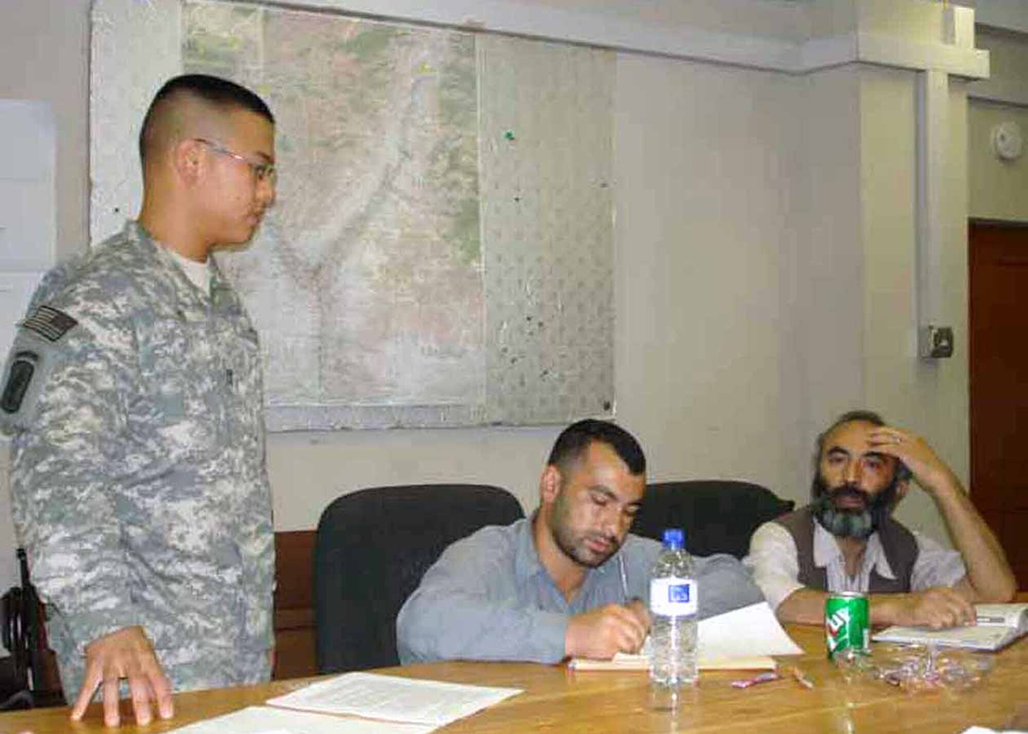 FORWARD OPERATING BASE MEHTAR LAM Afghanistan -- Air Force Captain Peter Joo (left), Mehtar Lam Provincial Reconstruction Team engineer, briefs Mangal Olafat (center), Noori Construction Company president, and Dr. Wododullah Noori (right), Mehtar Lam Director of Public Health, on the details of the Tuberculosis (TB) clinic. The three hundred thousand dollar contract is for a new Mehtar Lam TB clinic which is expected to take 180 days to complete. (photo courtesy of Capt. Heather Kekic)