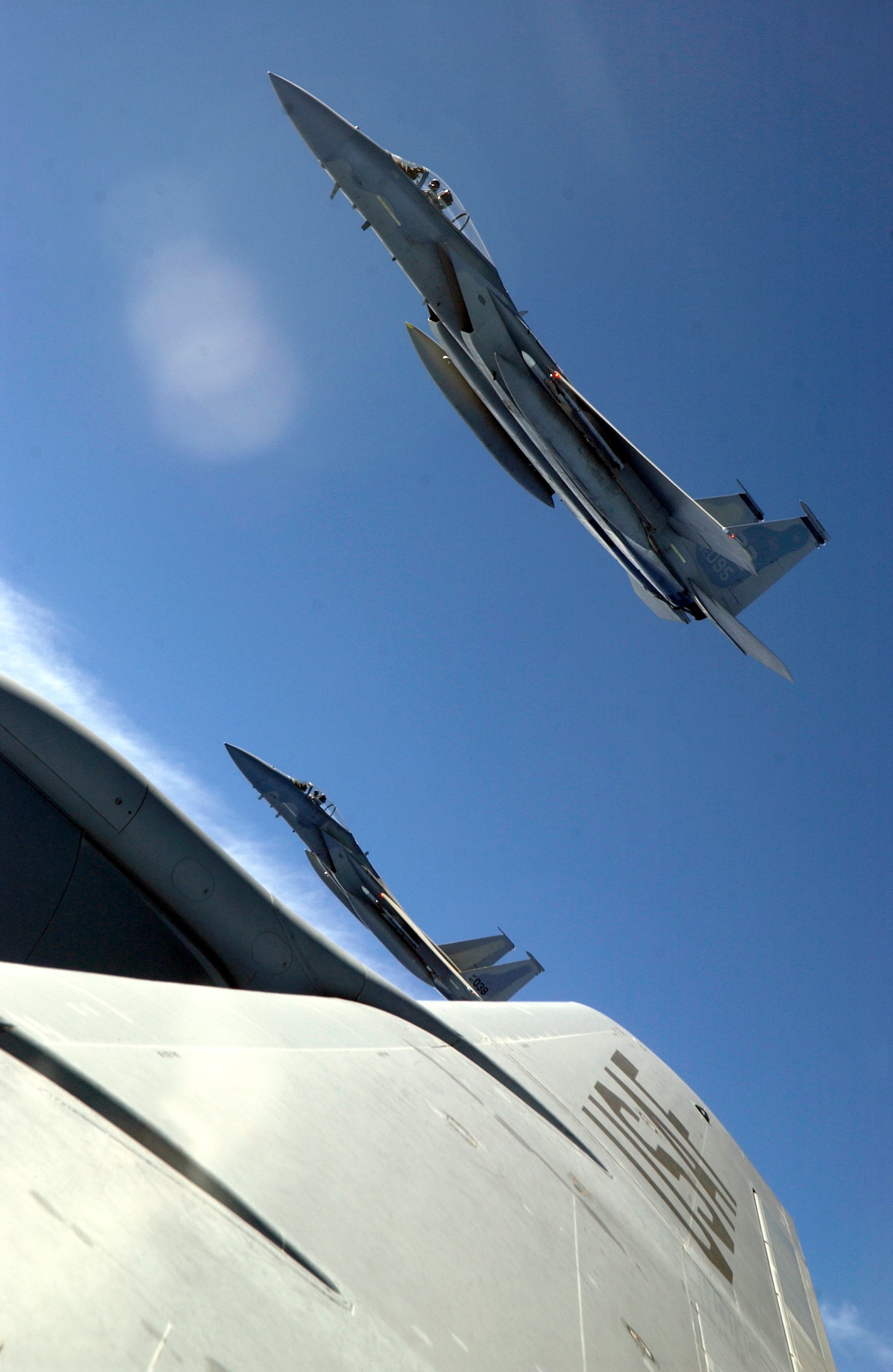ANDERSEN AFB, GUAM - An F-15 deployed here from the 44th Fighter Squadron, Kadena Air Base, Japan,  flies along side a KC-135 Stratotanker, from the New Hampshire Air Nation Guard, during Valiant Shield, Aug. 9, 2007.  During the exercise, U.S. Air Force aircraft and personnel from stateside bases and Kadena Air Base, Japan, work together as part of an expeditionary air wing based at Andersen AFB, Guam. Andersen AFB will also be the beddown location for approximately 64 U.S. Air Force and 29 U.S. Navy aircraft, plus transient aircraft, during Valiant Shield. Valiant Shield 07, the largest joint exercise in recent history, includes 30 ships, more than 280 aircraft and more than 20,000 service members from the Navy, Marine Corps, Air Force and Coast Guard. (U.S. Air Force photo by Senior Airman Miranda Moorer) 