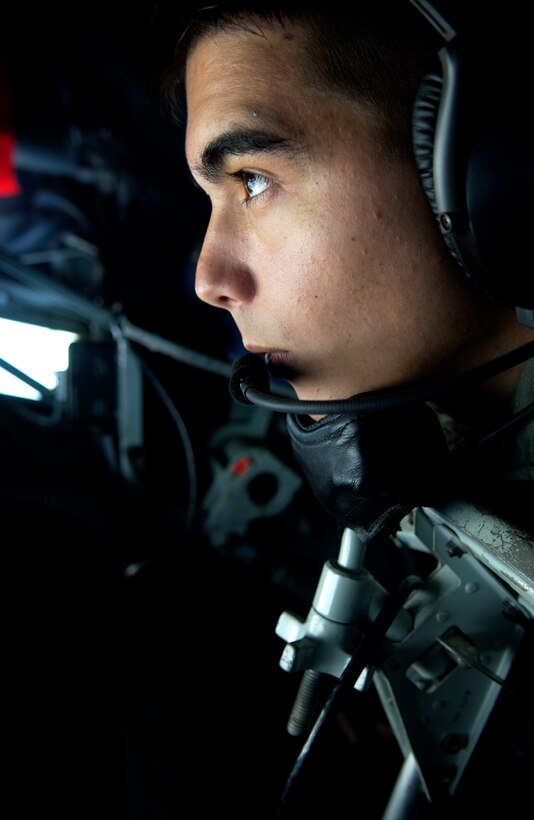 ANDERSEN AFB, GUAM - Airman 1st Class Geoffry Schultz, a New Hampshire Air National Guard boom operator, looks out over the Pacific from a  KC-135 Stratotanker, during Valiant Shield Aug. 9, 2007.  During the exercise, U.S. Air Force aircraft and personnel from stateside bases and Kadena Air Base, Japan, work together as part of an expeditionary air wing based at Andersen AFB, Guam. Andersen AFB will also be the beddown location for approximately 64 U.S. Air Force and 29 U.S. Navy aircraft, plus transient aircraft, during Valiant Shield. Valiant Shield 07, the largest joint exercise in recent history, includes 30 ships, more than 280 aircraft and more than 20,000 service members from the Navy, Marine Corps, Air Force and Coast Guard. (U.S. Air Force photo by Senior Airman Miranda Moorer) 