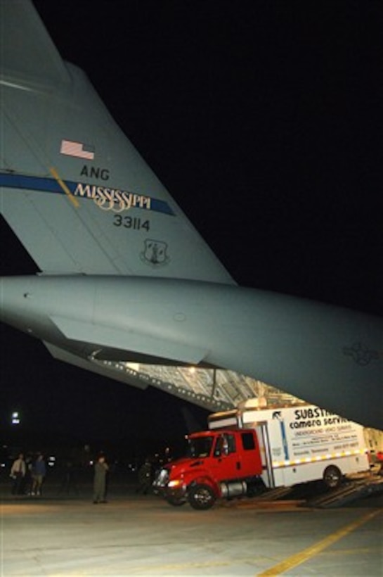 A commercial camera service truck is offloaded from a U.S. Air Force C-17 Globemaster III aircraft in Salt Lake City, Utah, on Aug. 9, 2007, to assist in rescue operations for the six stranded Utah miners.  The equipment will allow rescuers the ability to position a camera in the mine and assess the situation from a 360-degree angle and develop a better idea of conditions inside the collapsed mine.  The C-17 is attached to the Mississippi Air National Guard.  