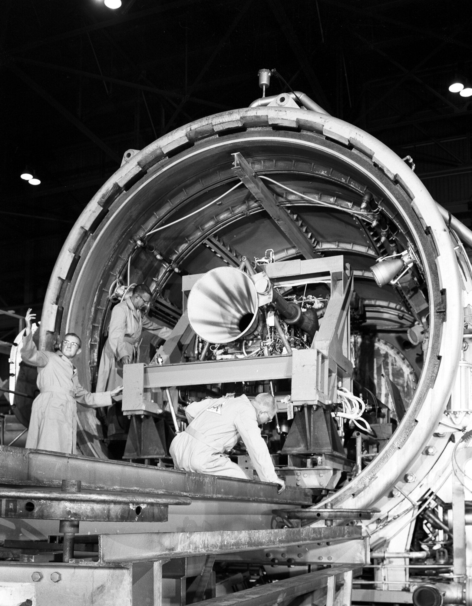 The largest rocket propulsion unit tested in AEDC’s Engine Test Facility up until Sept. 1959, was Reaction Motor’s 50,000-pound-thrust liquid-propellant engine for the X-15 Research Aircraft.  Purpose of the test was to determine the starting and throttling capabilities of the engine under high altitude conditions.  Altitudes from 20,000 to 70,000 feet were simulated in the test cell, and a total of twenty starts were made during the first phase of the test program…five being made during one five-hour test period.