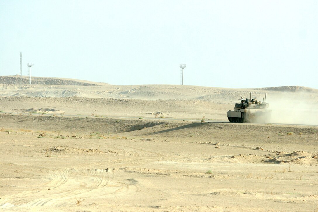 COMBAT OUTPOST RAWAH, IRAQ – A tank with Company B, 1st Tank Battalion, supporting Task Force Highlander, Regimental Combat Team 2, sweeps through the Iraqi desert in the Al Anbar province in support of Operation Punisher III. Operation Punisher III was an ongoing part of the regimental-wide Operation Mawtini, which is aimed at countering an insurgent surge of activity in the Al Anbar province, as well as disrupting the flow of weapons and other illegal items toward the urban areas. Official Marine Corps Photo By Cpl. Ryan C. Heiser.