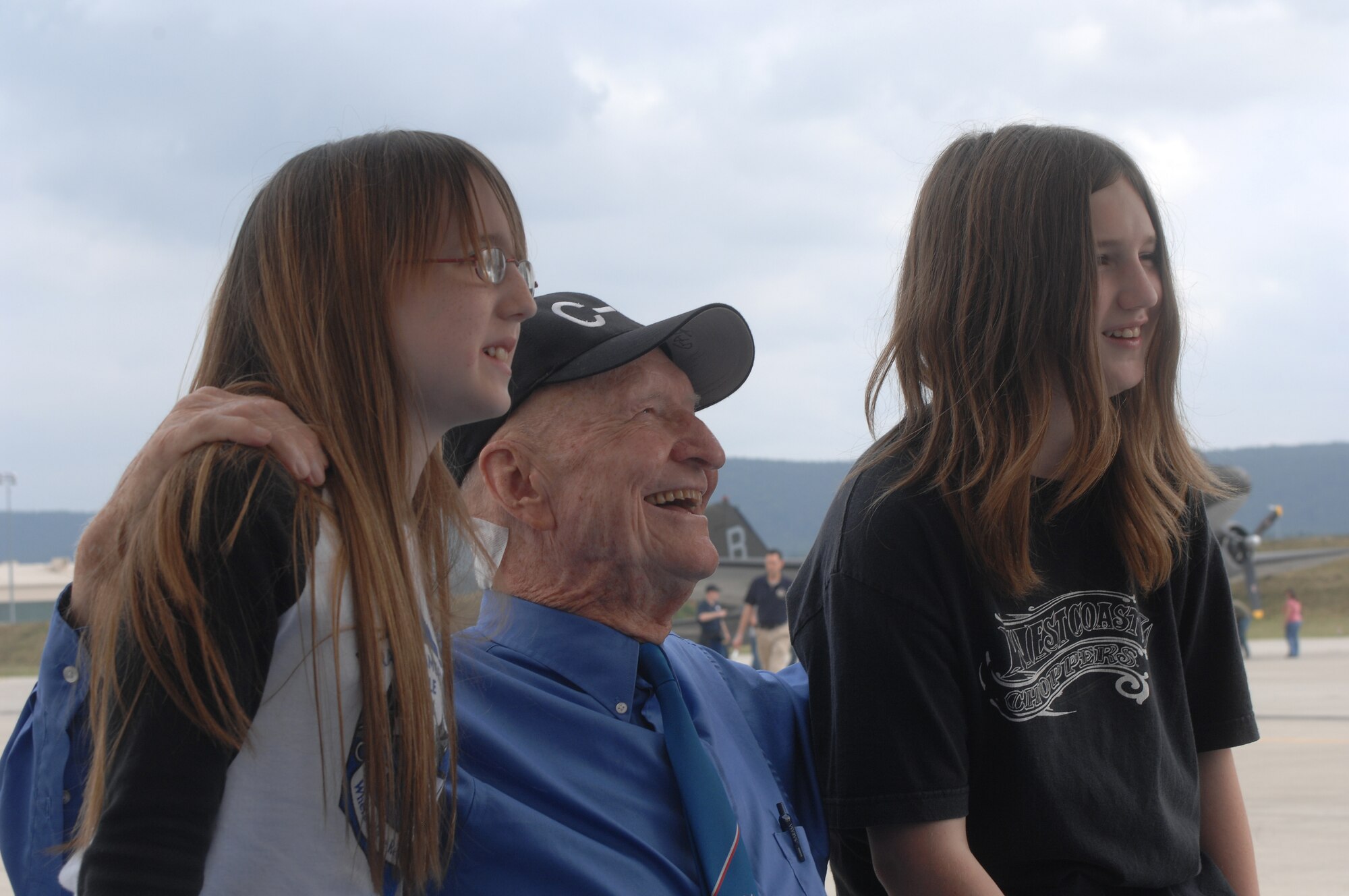 Col. (Ret) Gail Halvorsen, the Berlin Candy Bomber, takes a break from signing autographs for a photo opportunity with Natasha and Alex Harris during U.S. Air Forces in Europe's Air Force 60th Anniversary celebration held at Ramstein Air Base, Germany, August 11, 2007. (U.S. Air Force photo by Airman 1st Class Kenny Holston)(RELEASED)     