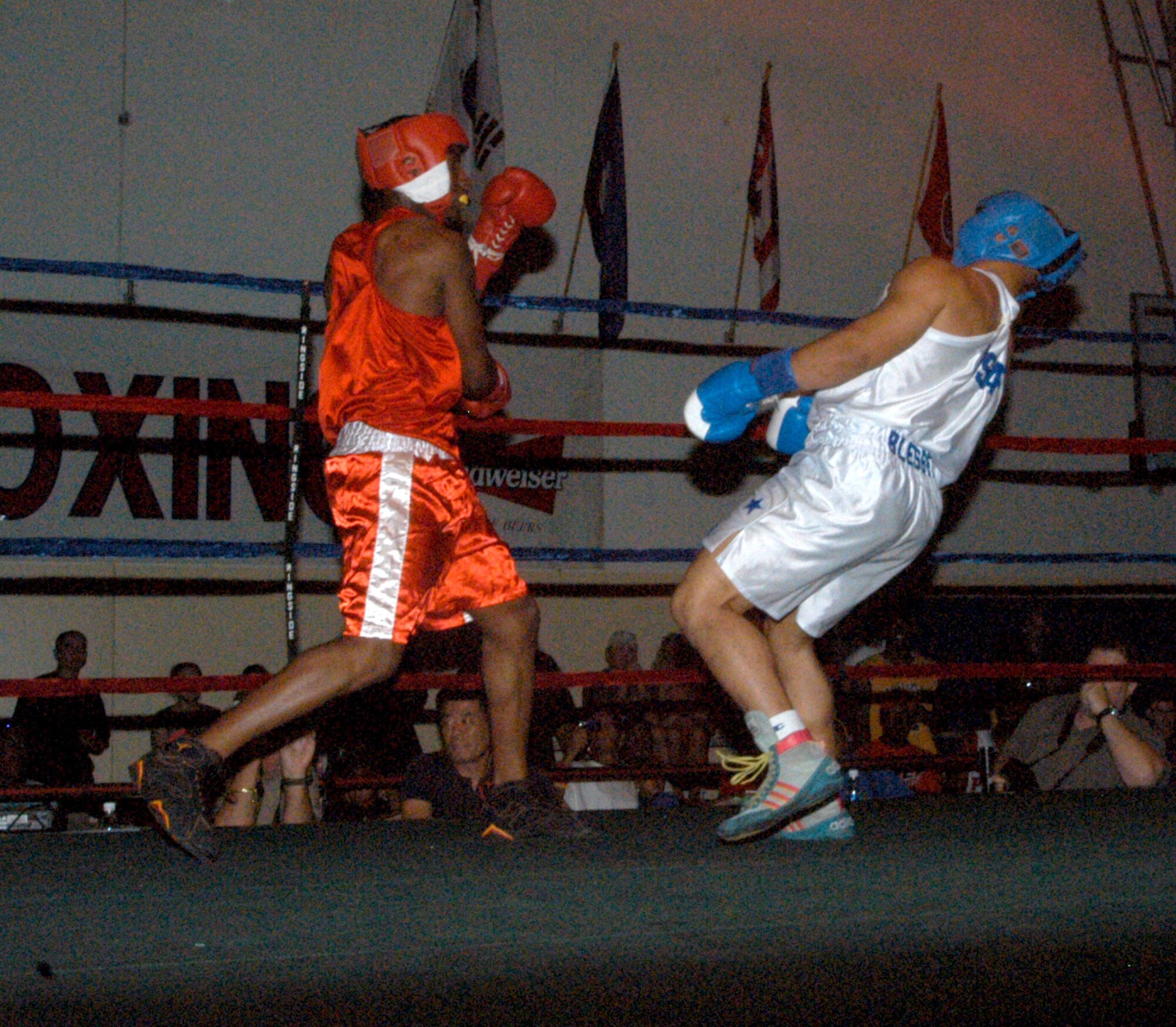 U.S. ARMY GARRISON HUMPHREYS, South Korea -- Avery Robinson, stationed here, lays into Kunsan Air Base's Vincent Reed, forcing him to the mat during the 2007 summer Smoker Boxing Tournament Aug. 11 here. Even though he tired himself out in the first round with lightning punches, Robinson still took the win by split decision. (U.S. Air Force photo/Staff Sgt. Darcie Ibidapo)