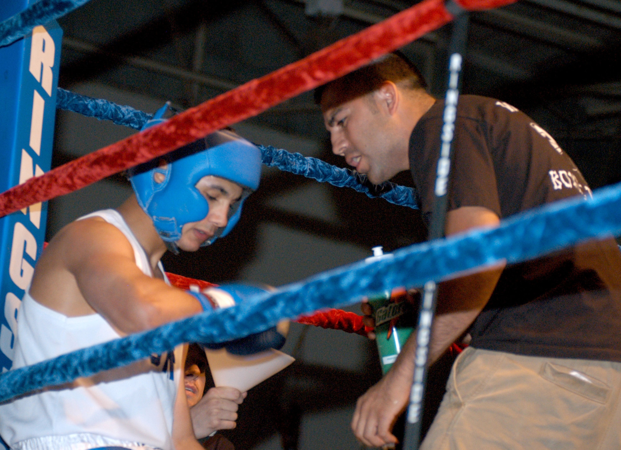 U.S. ARMY GARRISON HUMPHREYS, South Korea - Richard Mora, Kunsan Air Base boxing coach, directs boxer Juan Flores during the 2007 summer Smoker Boxing Tournament on Aug. 11 here. Flores, representing Kunsan AB, defeated Steve Jordan from Osan AB.  (U.S. Air Force photo/Staff Sgt. Darcie Ibidapo)