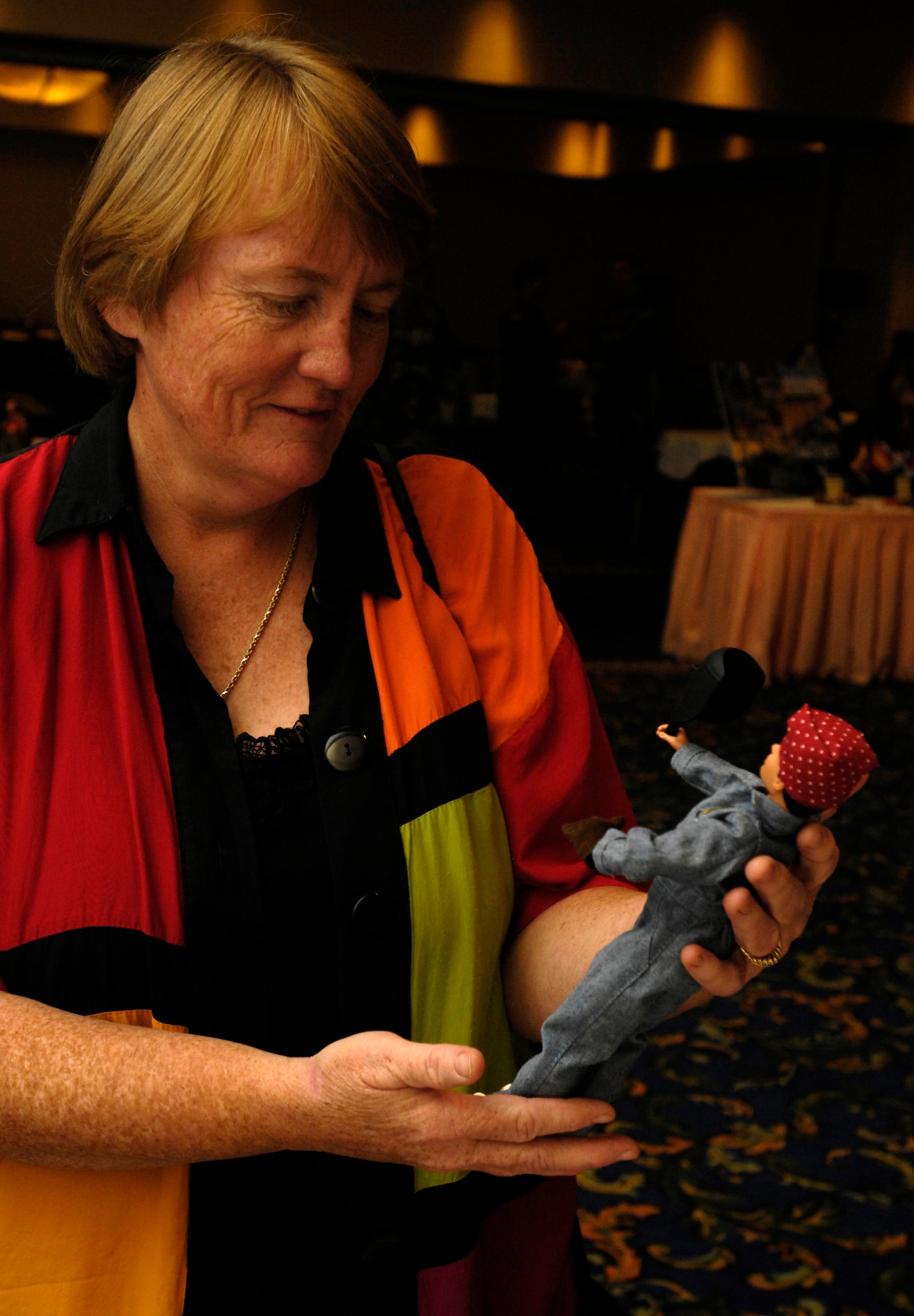 VANDENBERG AIR FORCE BASE, Calif. -- Donna Rathbun, 30th Space Wing Sexual Assault Prevention and Response coordinator, looks at a Rosie the Riveter doll at the women's history month booth during the Cultural Heritage Day event on Aug. 10. Vandenberg's Cultural Heritage Day combined all annual cultural observances into one gala event of food, music, dance and displays. (U.S. Air Force photo/Airman 1st Class Christian Thomas)