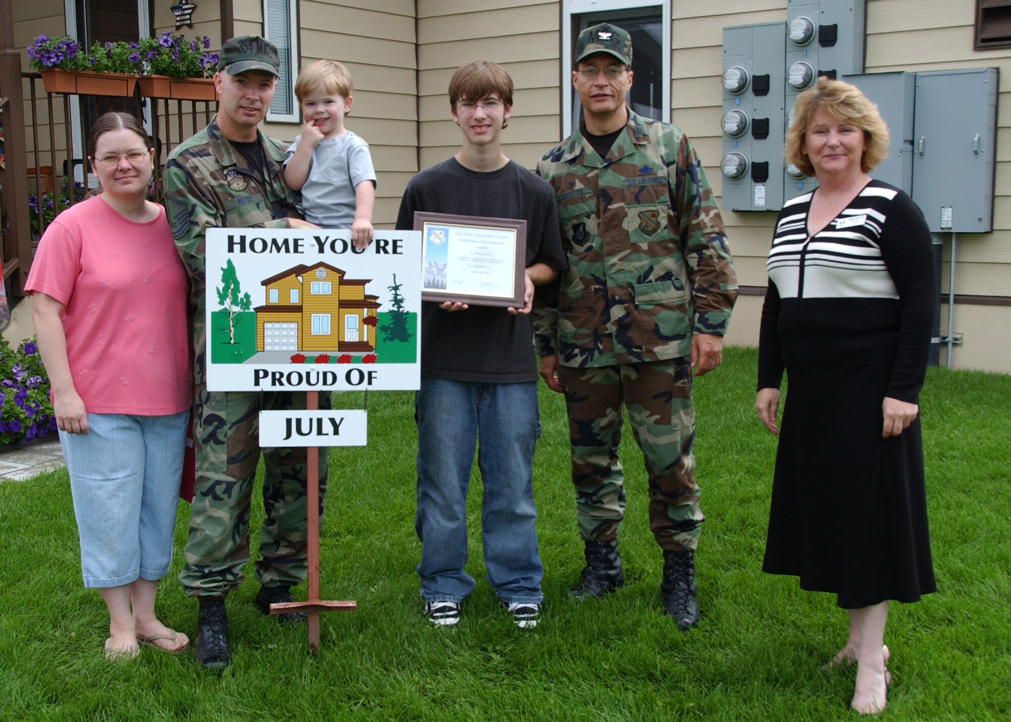 EIELSON AIR FORCE BASE, Alaska--Master Sgt. Sammy Pettit, 354th Maintenance Squadron, wife, Tina, and sons Stephen and Benjamin, pose with Lorie Dallas, 354th Civil Engineer Squadron military family housing, and Col. John Stutts, 354th Mission Support Group commander, for winning the July Home You're Proud Of for Area 2. Each home to win received $75 in gift certificates from agencies on and off base. Not available for a photo was Tech. Sgt. Sheryl Baker, 354th Force Support Squadron, who won HYPO for Area 1. (U.S. Air Force photo by Airman 1st Class Christopher Griffin)                