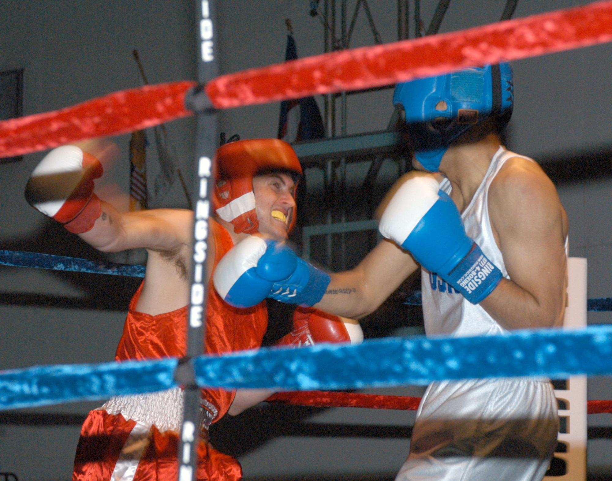 Gregory Shoopman (left), representing U.S. Army Garrison Humphreys, takes on Sergio Sanchez from Kunsan Air Base during the 2007 summer Smoker Boxing Tournament on Aug. 11 at USAG Humphreys. Sanchez defeated Shoopman in the three-round bout. (U.S. Air Force photo/Staff Sgt. Darcie Ibidapo) 