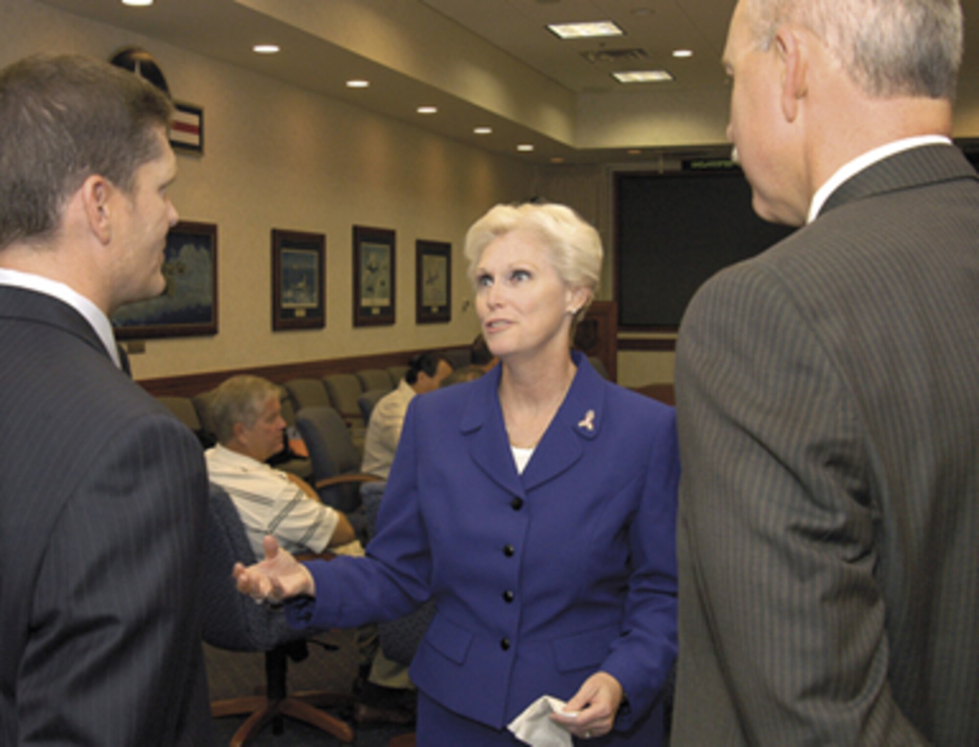 Air Force Materiel Command Executive Director Barbara Westgate visits with James Schmidt, American Federation of Government Employees Local 916 president, left, before a meeting of AFMC and local union officials at Tinker Air Force Base, Okla. Looking on is John Over, Oklahoma City Air Logistics Center Executive Director. (Air Force photo by Margo Wright)