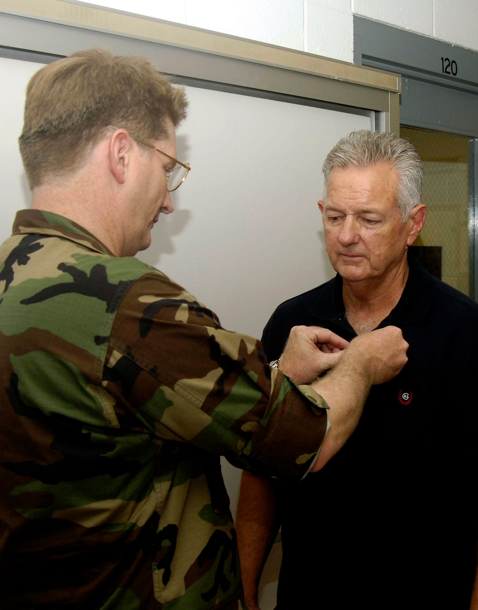 Col. Robert Thomas, 6th Air Mobility Wing commander, pins the Purple Heart on Vietnam veteran Wayne Sufficool, Aug. 9, at MacDill Air Force Base, Fla. Mr. Sufficool was awarded the decoration for wounds he suffered while stationed in Tan Son Nhut Air Base, Republic of Vietnam, in February 1968. (U.S. Air Force photo/Senior Airman David Minor)