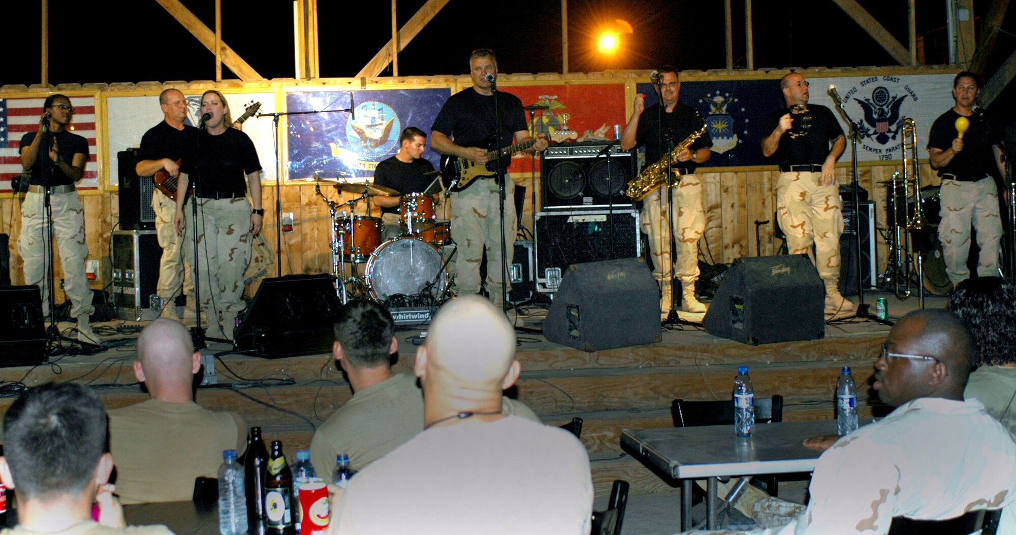 The U.S. Central Command Air Forces band "Thunder Roll" plays to a crowd of servicemembers at Camp Lemonier Aug. 10 during their Africa tour. Thunder Roll tours approximately 80 days out of the year to expeditionary locations around the world. (U.S. Army photo/Sgt. Brandon McCarty) 