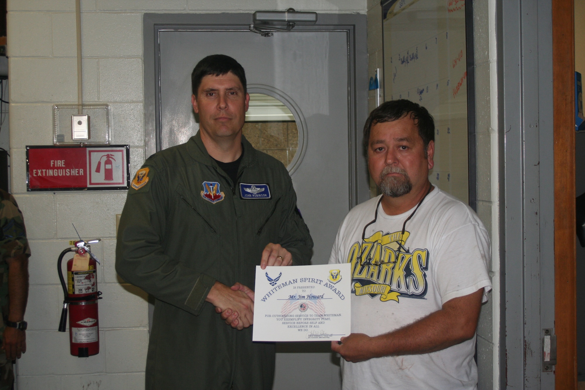 WHITEMAN AIR FORCE BASE, Mo. -- Col. John Robinson, 509th Bomb Wing vice commander, presents the Whiteman Spirit Award to Jim Howard, 509th Civil Engineer Squadron, Aug. 13. (U.S. Air Force photo/Maj. Joe DellaVedova)