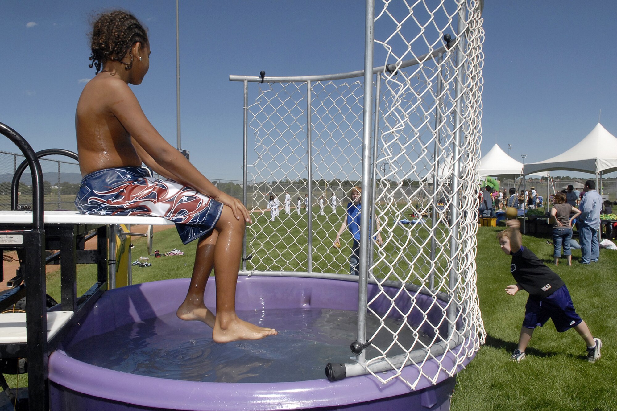 With the summertime heat, the dunk tank was a popular event Aug. 11 at the 2007 Kids Fair. Hundreds of military members and their families attended the fair, hosted by the 21st Services Squadron. (U.S. Air Force photo by Rob Bussard)