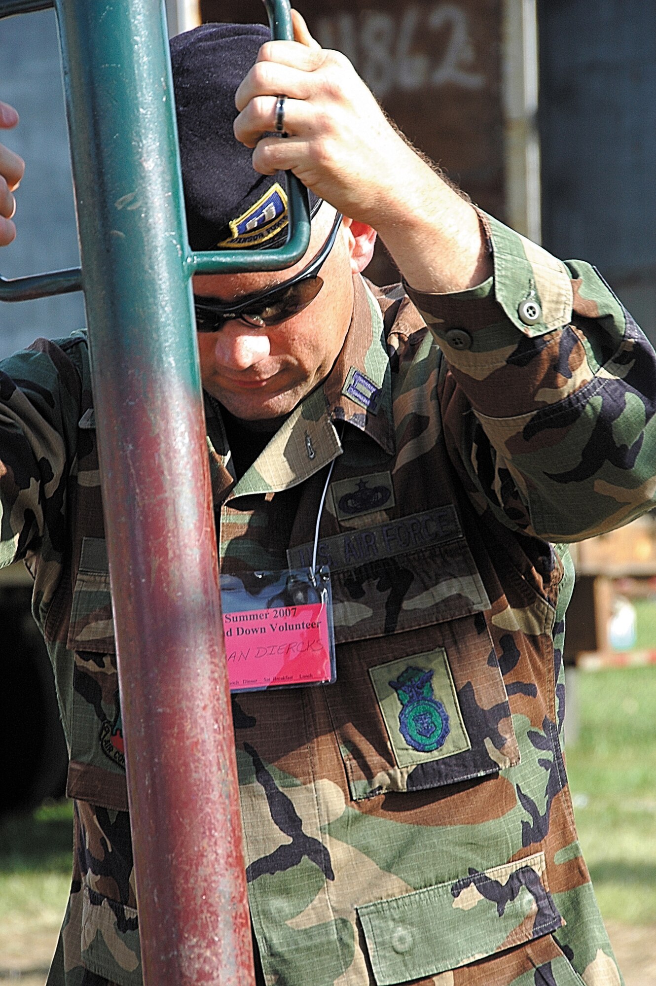 Capt. Dan Diercks, 442nd Security Forces Squadron commander, pounds a tent pole into the ground in Kansas City for the Heart of America Veterans Stand-down.  The June event is designed to serve Kansas City-area homeless veterans.  Volunteers build a tent city to house veterans, then provide various, need-based services.  Captain Diercks is an Air Force reservist with the 442nd Fighter Wing at Whiteman Air Force Base, Mo.  (U.S. Air Force photo/Maj. Anne Yelderman)