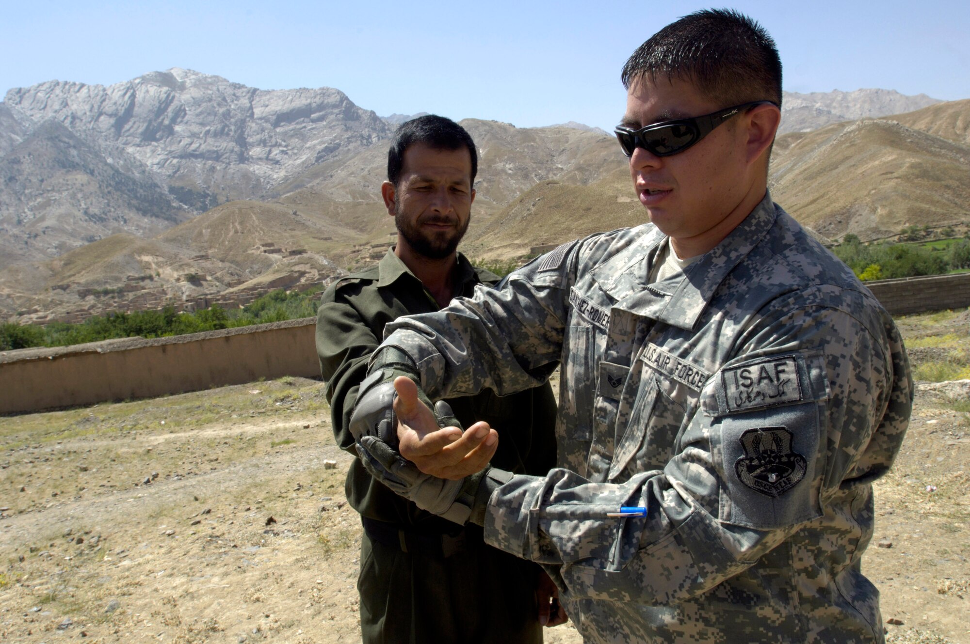 Staff Sgt. Andre Sanchez-Romero demonstrates how to escape from a wrist lock to a member of the Afghan National Police Aug. 6. The security forces Airman, a member of the Panjshir Provincial Reconstruction Team, traveled with other PRT members to the Anaba district of Panjshir Province, Afghanistan, to provide training to ANP working in the district.  Sergeant Sanchez-Romero is deployed from Minot Air Force Base, N.D.  (U.S. Air Force photo/Master Sgt. Jim Varhegyi)