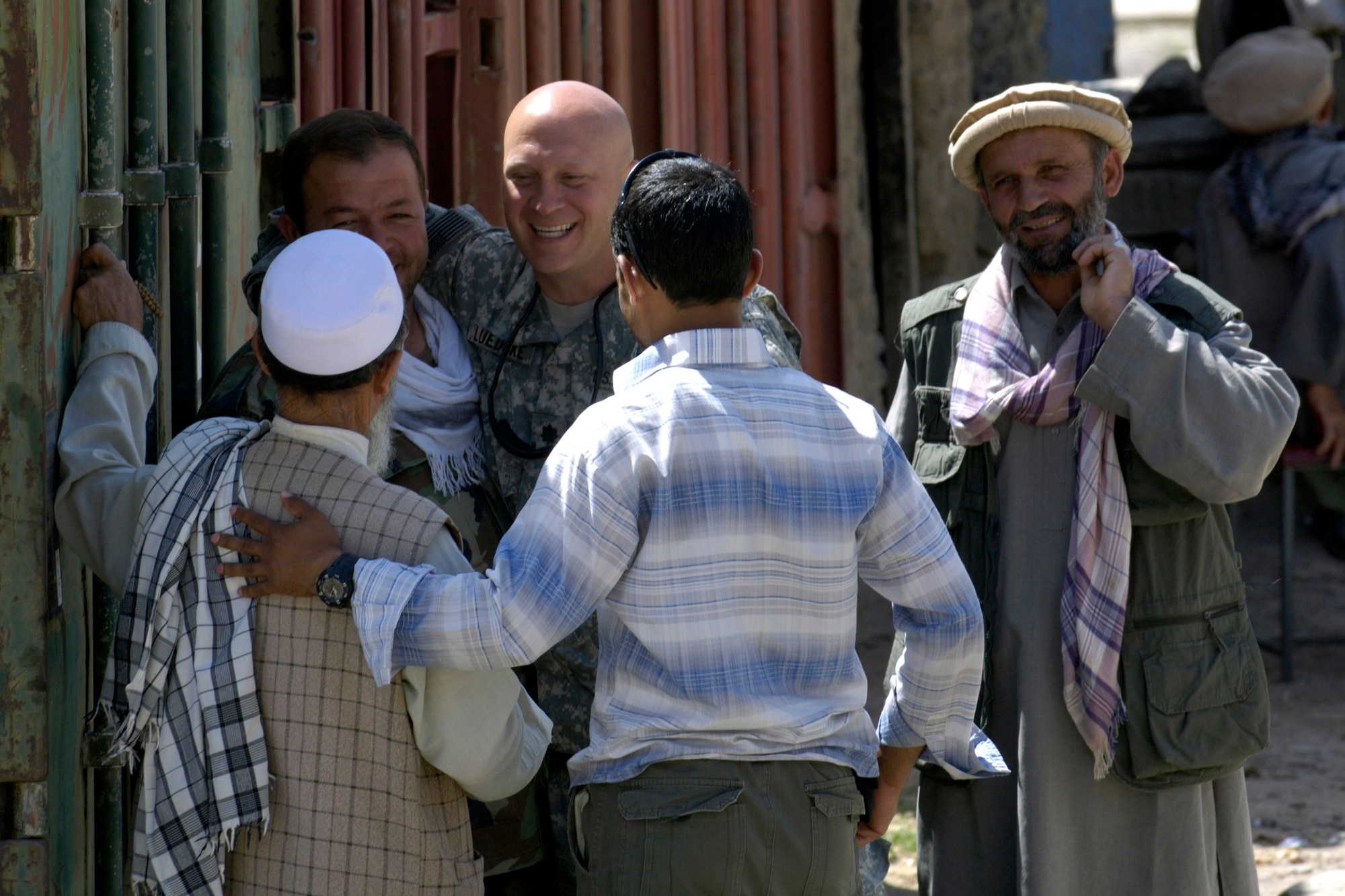 Lt. Col. Christopher Luedtke talks with locals living in the Anaba district of Panjshir Province, Afghanistan, Aug. 6.  Colonel Luedtke, commander of the Panjshir Provincial Reconstruction Team, brought members of his PRT to Anaba to provide training to Afghan National Police serving in the area. Colonel Luedtke is deployed from Hill Air Force Base, Utah. (U.S. Air Force photo/Master Sgt. Jim Varhegyi)