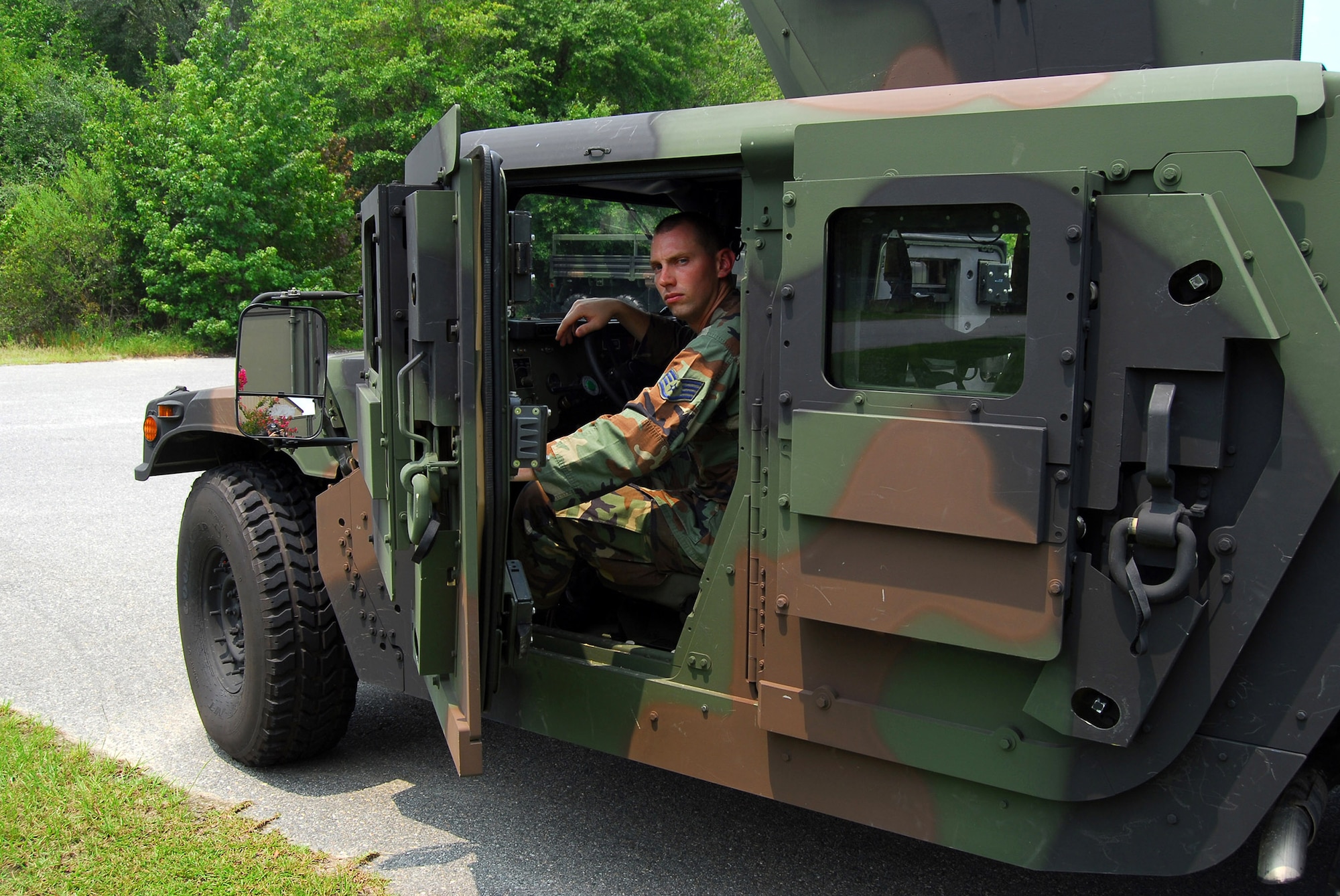 Staff Sgt. Tim Bele performs an inspection of one of the 820th Security Forces Group's armored Humvees equipped with Frag 5 armor Aug. 6 at Moody Air Force Base, Ga. The vehicle's 600-pound doors and additional armor plating help protect crews from improvised explosive devices. Sergeant Bele is a vehicle maintenance craftsman. (U.S. Air Force photo/Tech. Sgt. Parker Gyokeres)
 
