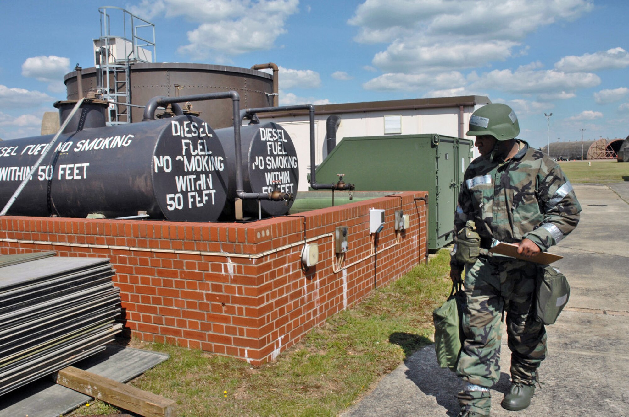 Staff Sgt. Jermaine Harvey conducts a sweep to check for unexploded ordnance outside the squadron operations center during an operations evaluation July 31 at Royal Air Force Lakenheath, England.  In this portion of the ops eval, the squadron operations center has been "damaged by mortar fire."  (U.S. Air Force photo/Airman 1st Class John Easterling)