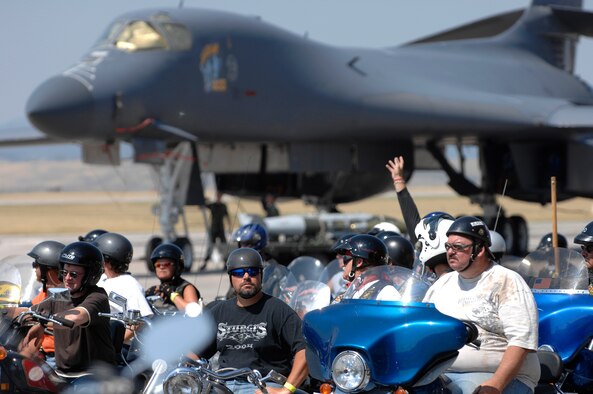 An out-of-state motorcyclist pictured sitting on the blue Harley, known as "Big Tim" waits for the ride to depart. He volunteered a ride home for the author after she was stranded due to a broken-down motorcycle. 
Nearly 350 riders from the Ellsworth Dakota Thunder Motorcycle Club and local community rode from Ellsworth to the 67th Annual Sturgis Motorcycle Rally Aug. 7. 
(U.S. Air Force photo/Staff Sgt. Michael Keller)