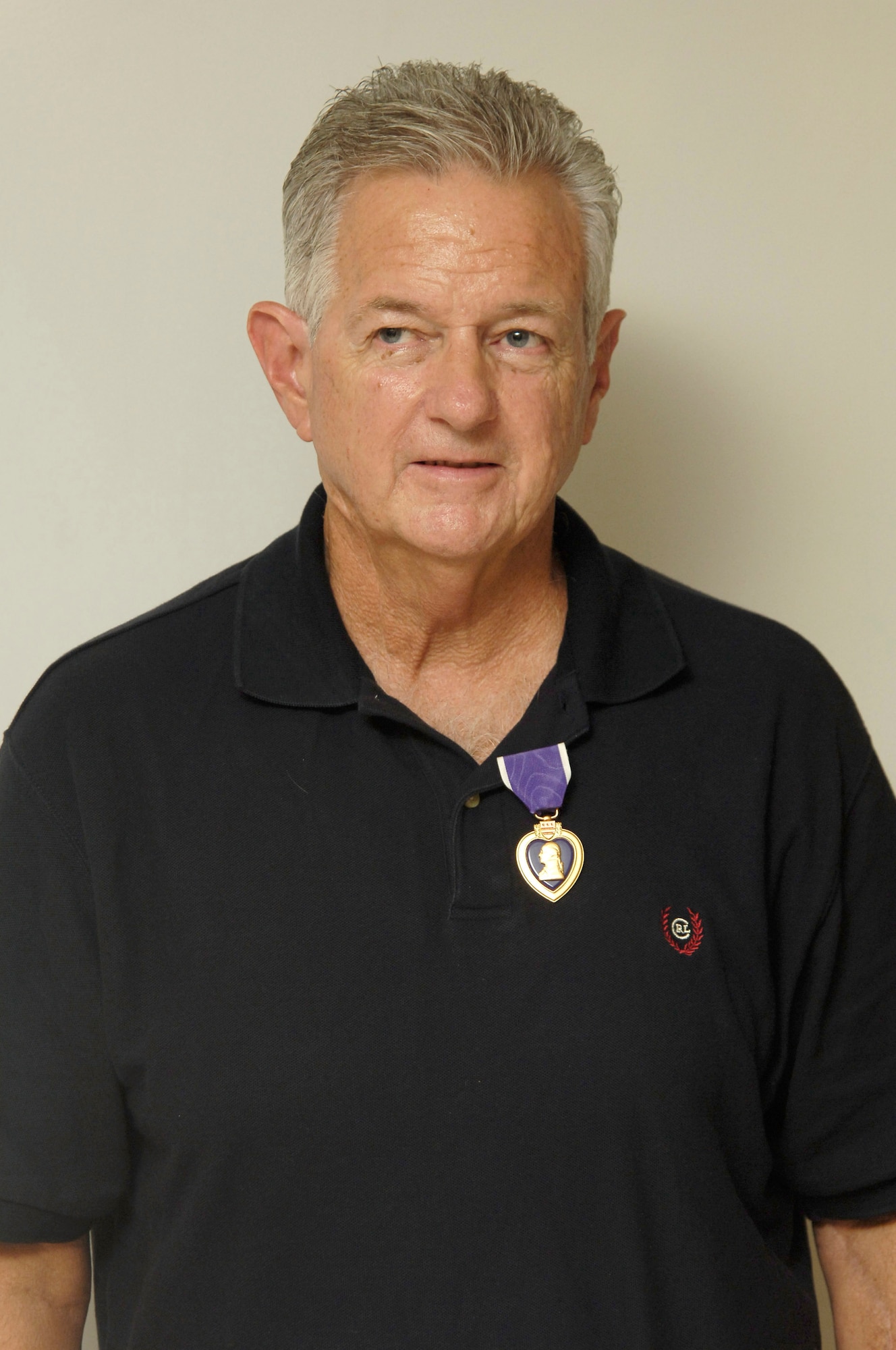 Wayne Sufficool, a former crew chief stationed at MacDill Air Force Base more than 39 years before, stands with his Purple Heart Decoration he was awarded Aug. 9, 2007.  Mr. Sufficool was awarded the decoration for the wounds he suffered while stationed in Tan Son Nhut Air Force Base, Republic of Vietnam, in February 1968. (Air Force Photo by Senior Airman David Minor)