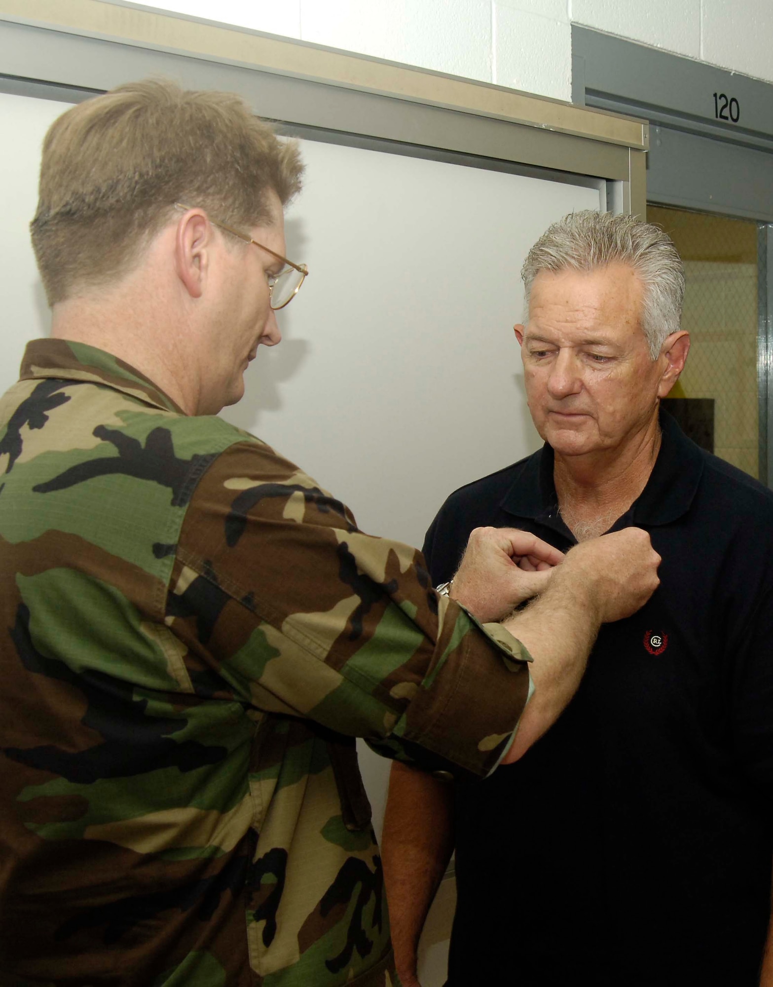 Col. Robert Thomas, 6th Air Mobility Wing commander, pins on the Purple Heart Decoration to Vietnam Veteran Wayne Sufficool Aug. 9, 2007, at MacDill Air Force Base,Tampa. Mr. Sufficool was awarded the decoration for the wounds he suffered while stationed in Tan Son Nhut Air Force Base, Republic of Vietnam, in February 1968. (Air Force Photo by Senior Airman David Minor)