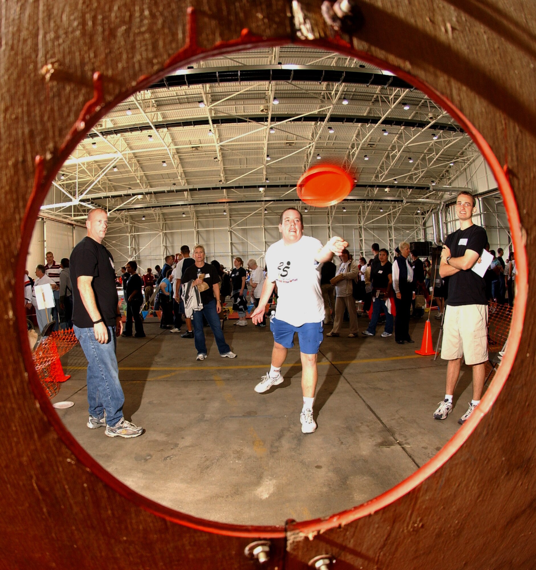 The Joan Mann Special Sports Day committee is looking for volunteers to help with this year's event. In this scene form last year's event, 2nd Lt. Kyle McDaniel, left, 48th Communications Squadron, and 1st Lt. Jeff Fries, right, 100th Operations Support Squadron, assist Daniel Green, center, from the Footsteps Club, during the Frisbee toss event. Other events included a basketball shoot (standing and seated), wheelchair slalom, and bowling. (U.S. Air Force file photo)