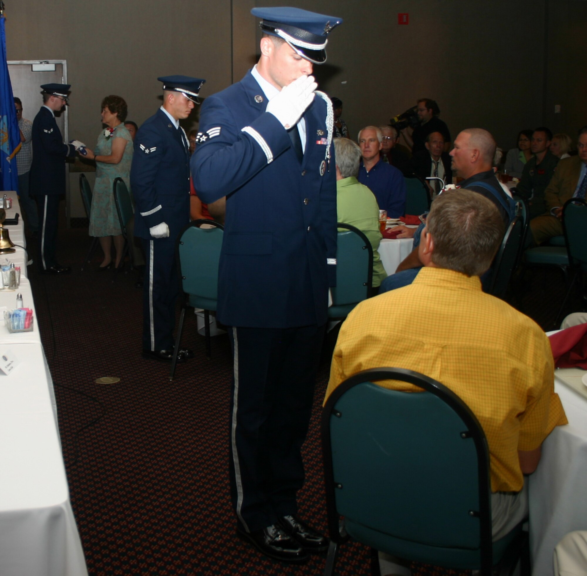 Members of the Sheppard Honor Guard present flags to the surviving family members of Air Force Maj. Troy Gilbert, Marine Sgt. Gary Johnston and Army Cpl. Ryan Collins at the Kiwanis Club recognition ceremony at Luby's Cafeteria Aug. 8. (U.S. Air Force photo/Staff Sgt. Tonnette Thompson)