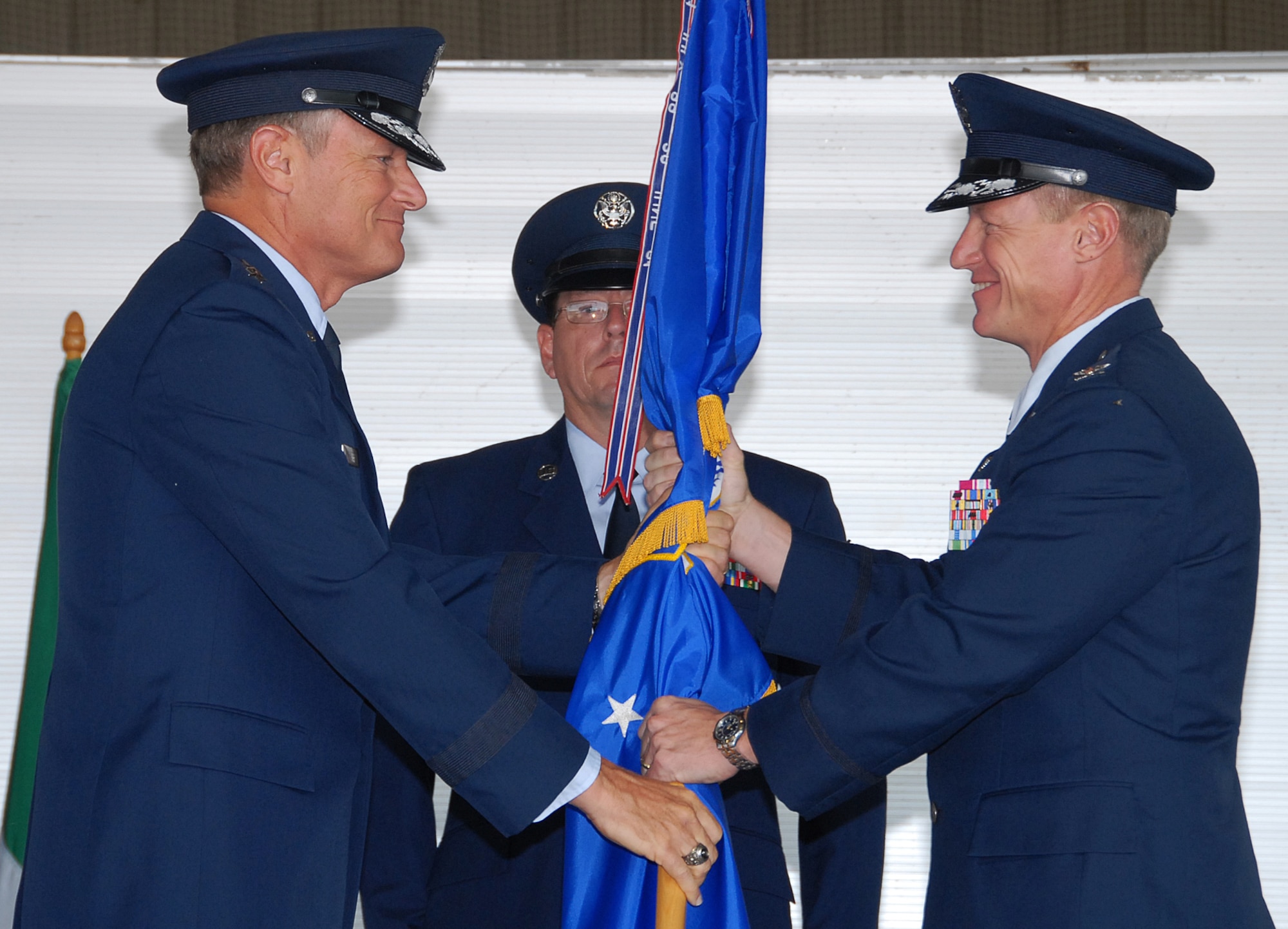 Maj. Gen. Irving Halter Jr., commander of the 19th Air Force, gives command of the 80th Flying Training Wing to Col. David Petersen during the change of command ceremony in Hangar 2048 Aug. 10. (U.S. Air Force photo/Mike Litteken)